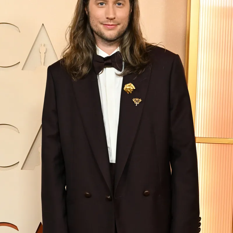 <p>Ludwig Göransson wears Boucheron Assyrian Lion brooch from 1920 in yellow gold, set with ruby and diamonds, Lion’s Head brooch from 1901, Quatre Radiant Edition wedding band in pink gold, set with brown PVD, Quatre Clou de Paris wedding band in yellow gold and Quatre Classique XS ring in white gold, yellow gold and pink gold, set with diamonds and brown PVD</p>