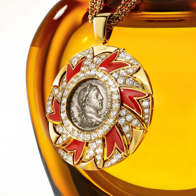 <p>A close-up of an Eclettica fragrance flacon, complete with a Roman coin – a Bvlgari signature</p>