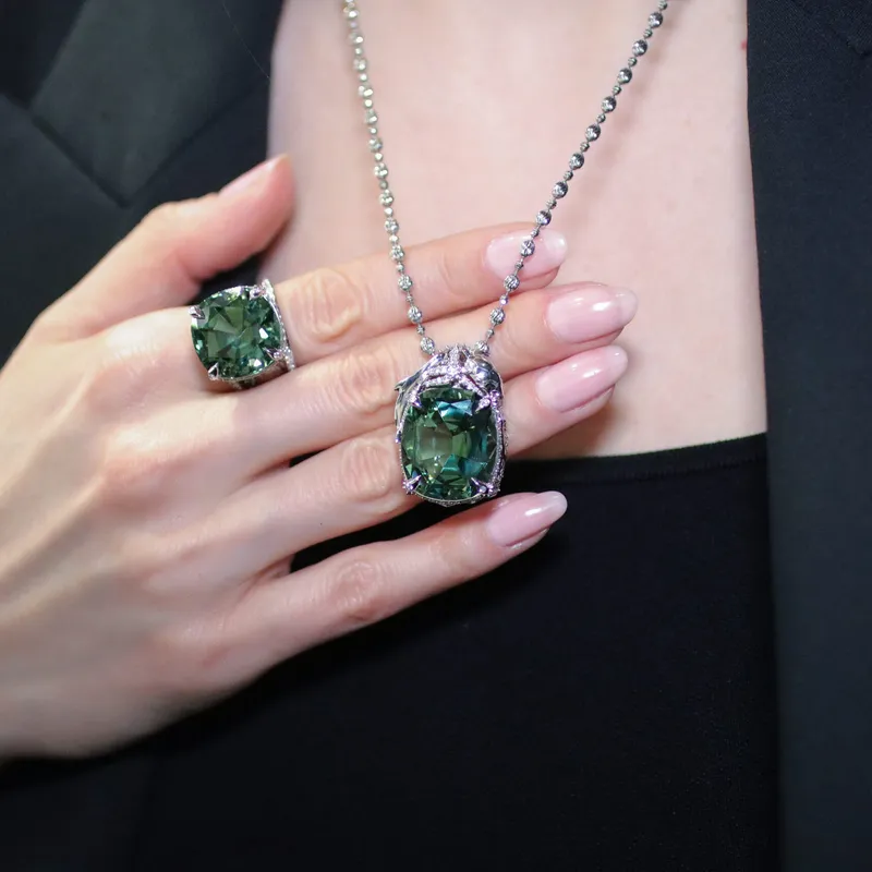 <p>Katerina Perez wears the Exuma ring and a matching pendant, the former set with a 25.85 carat cuprian colour-changing blue-green tourmaline</p>
