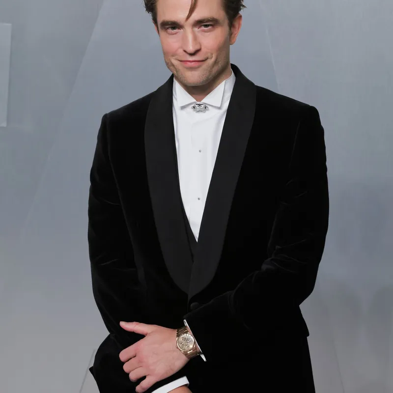<p>Robert Pattinson wears Cartier high jewellery necklace as a detachable brooch in platinum, set with onyx and diamonds and Santos de Cartier cufflinks in palladium-finish sterling silver and black lacquer</p>