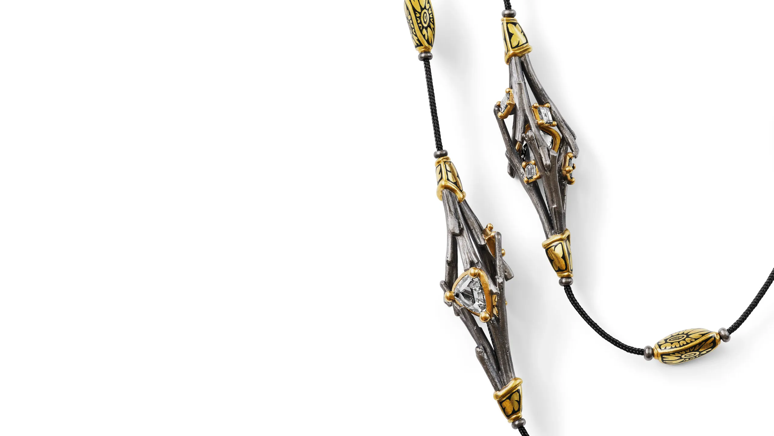 <p>The pair of necklaces were formed from real daylily stalks cast in white and yellow gold, their natural textures preserved in precious metal</p>