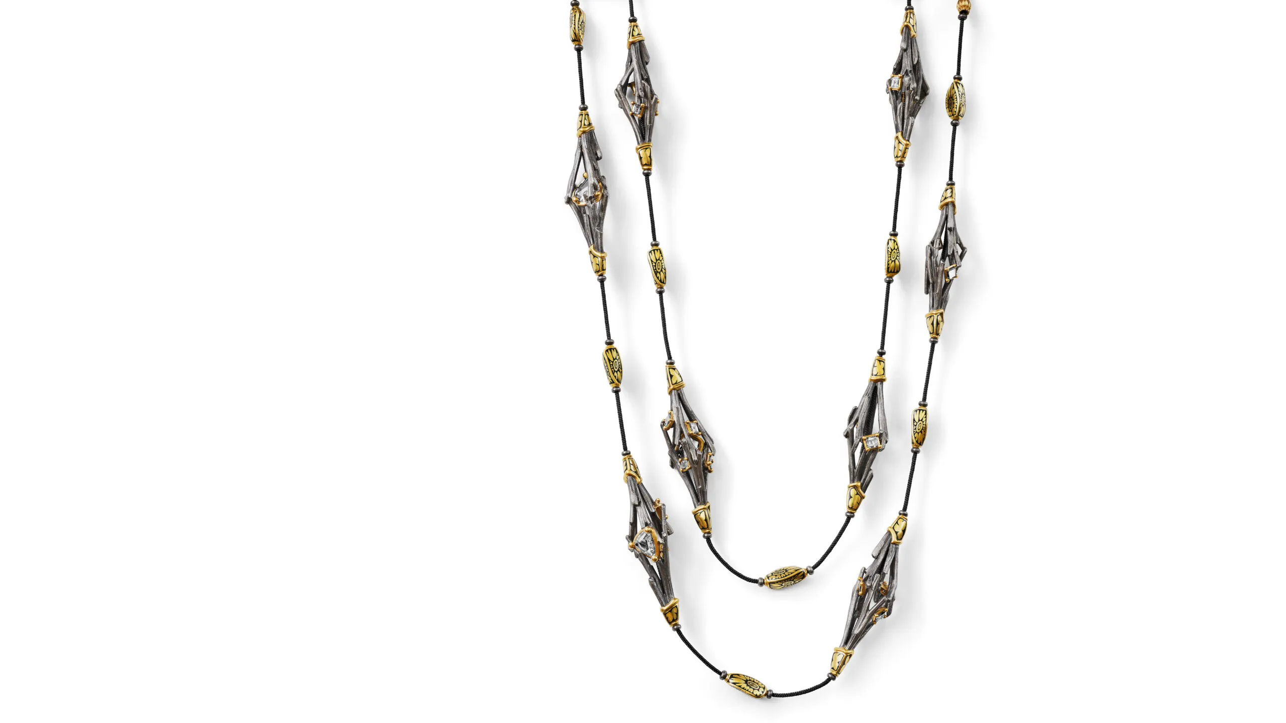 <p>Carré diamonds and antique Indian polki stones are set within the airy, geometric settings, bringing structure to the organic forms</p>