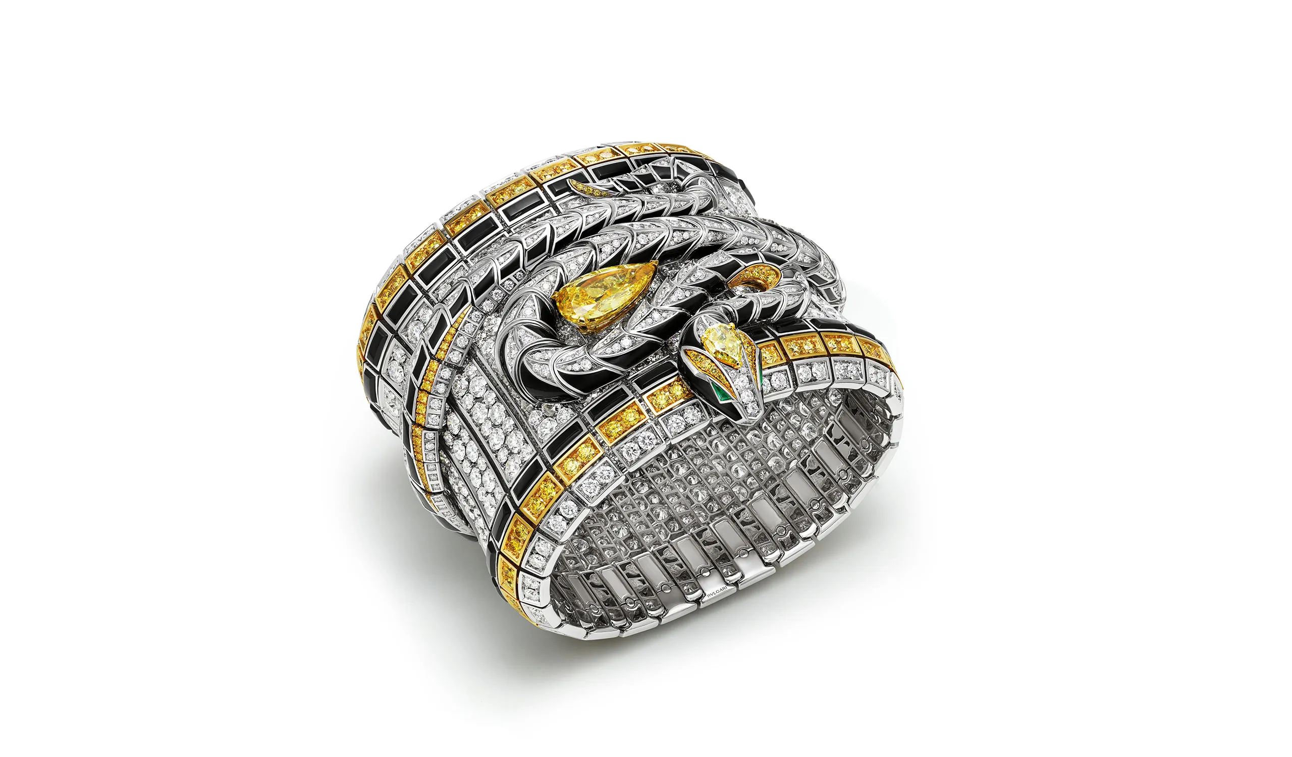 <p>The Eclettica Serpenti Spira high jewellery cuff set with Fancy Intense yellow diamonds, buff-top emeralds and pavé diamonds, in 18k white gold with onyx elements</p>