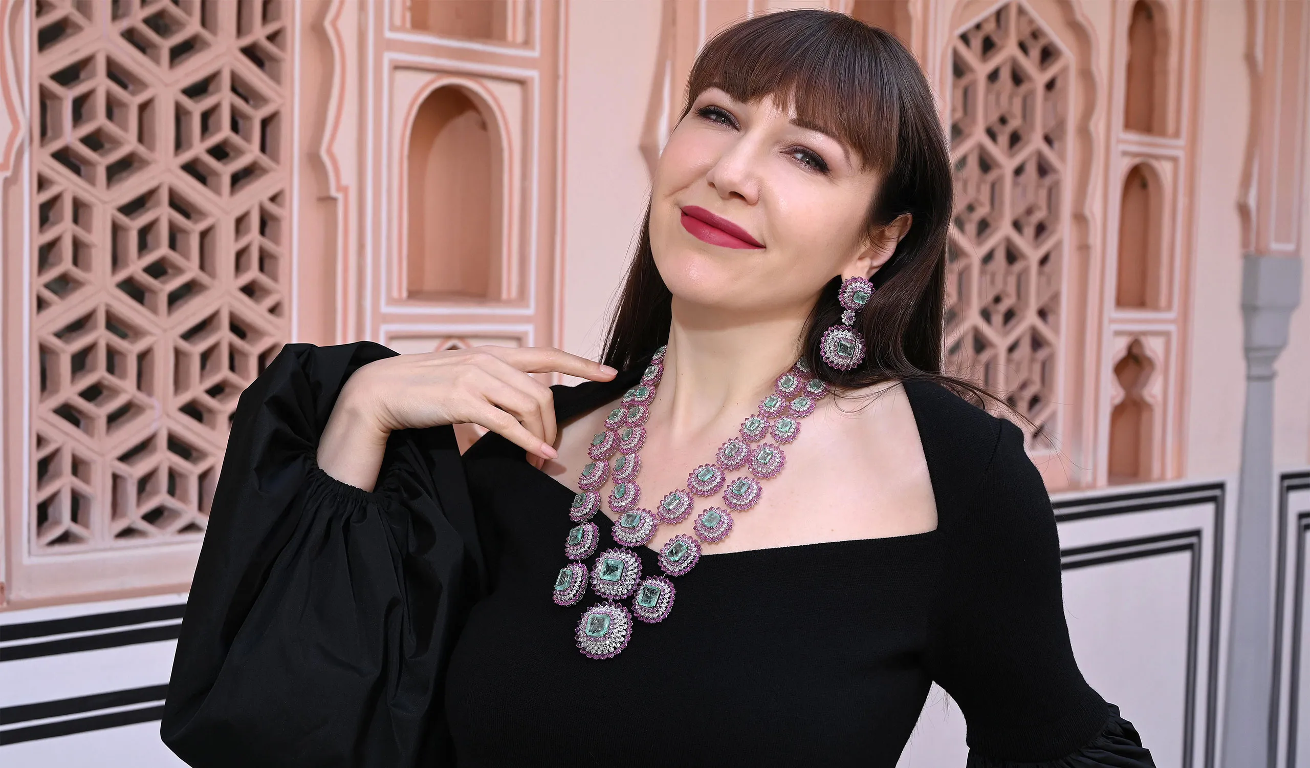 <p>Katerina Perez wears an impressive Diviano necklace set with 139 carats of Russian emeralds, 175 carats of pink sapphires and 36 carats of diamonds in 18k white gold</p>