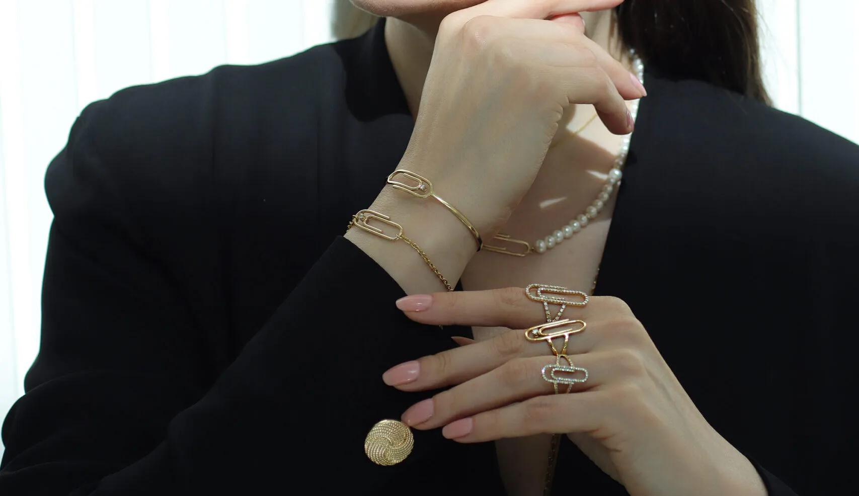 <p>Katerina layers NTERDI’s Clip rings and bracelets in 18k yellow gold and diamonds</p>