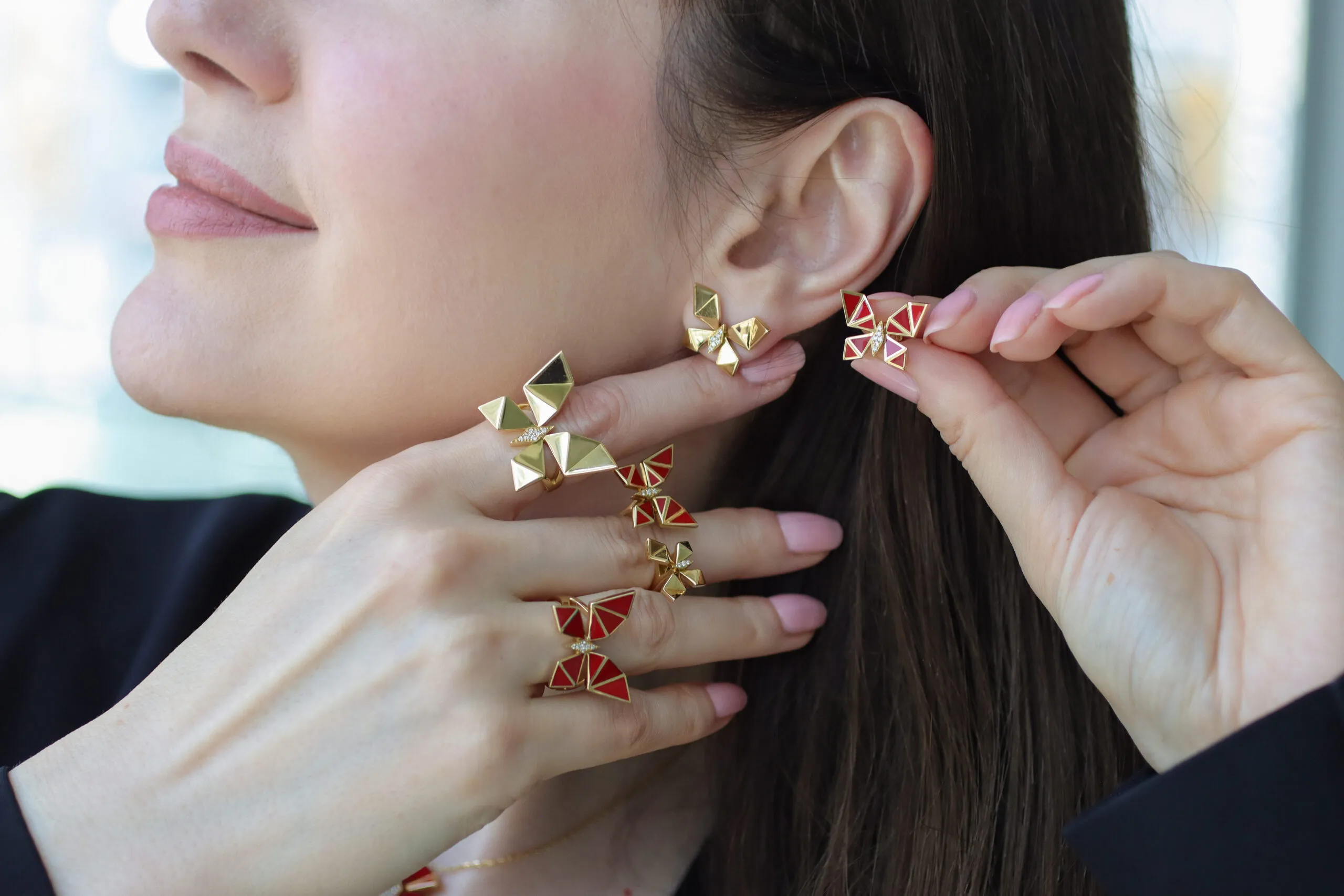 <p>A pair of Vol O Vent earrings play with asymmetry, with one crafted in 18k yellow gold and diamonds, the other red enamel</p>