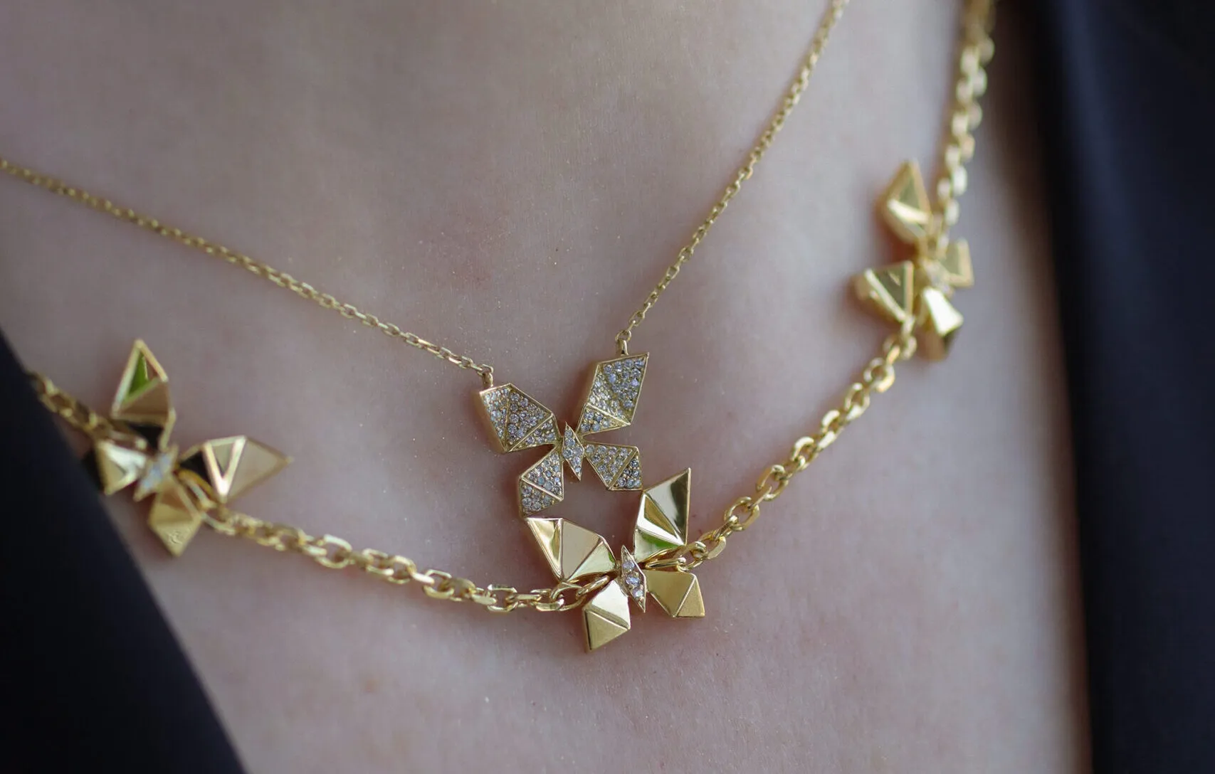 <p>Katerina layers the Vol O Vent 10 motif necklace and the double-sided pendant, with one side paved in diamonds, the other 18k gold</p>