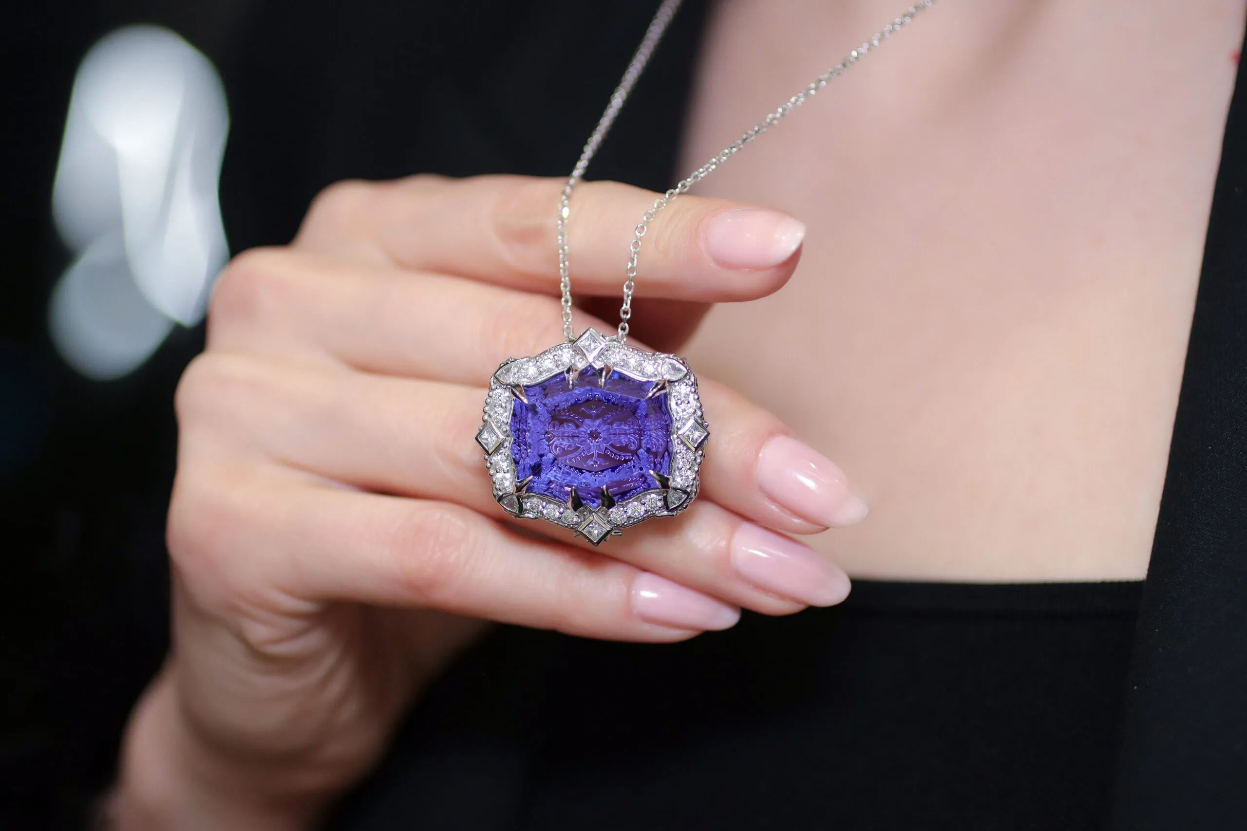 <p>Palm Beach Gems by Nicole Antique Dreams tanzanite pendant with a 51.57-carat tanzanite, engraved by renowned lapidary Dalen Hargave, plus 1.41 carats of diamonds and pink tourmalines set in 18k white gold</p>