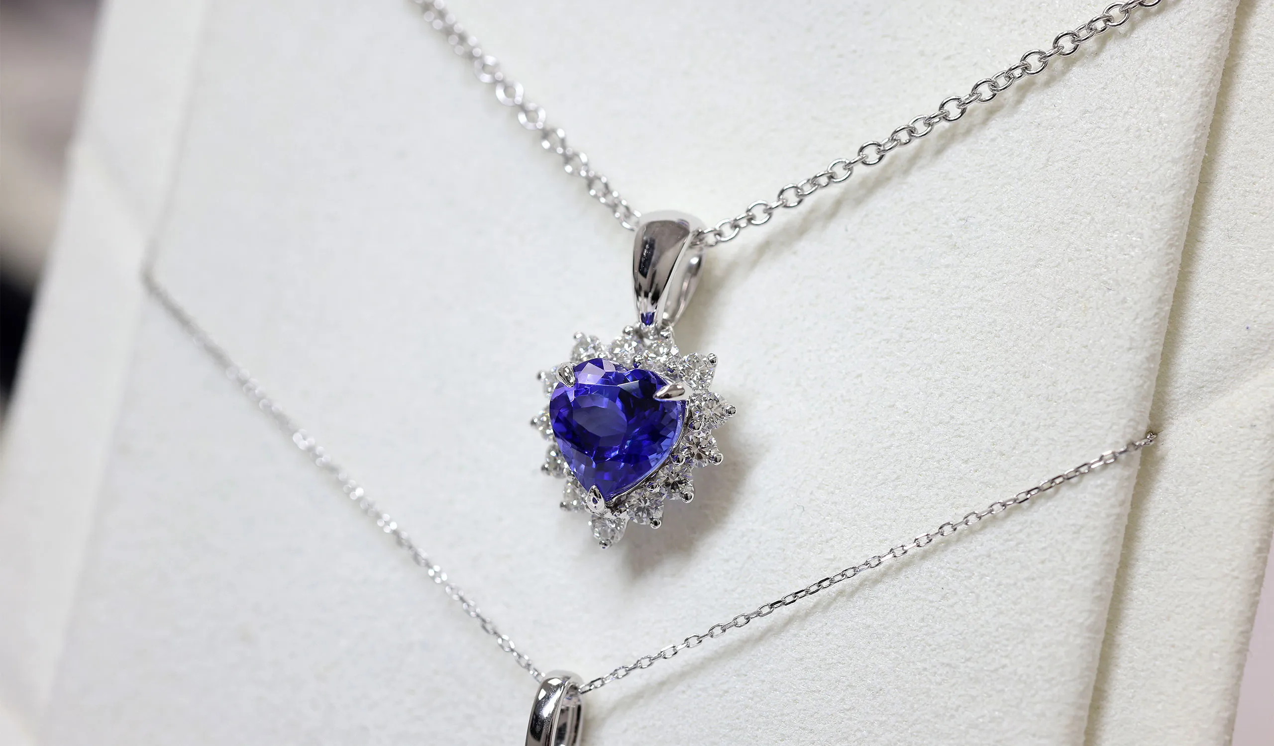 <p>A heart-shaped tanzanite cluster-style pendant, set with white diamonds, crafted by the Royal Touch Group</p>