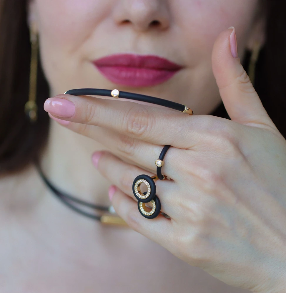 <p>The NTERDI Rubber Me collection explores the concept of flexibility, pairing supple black rubber with sleek yellow gold and flashes of diamond light</p>