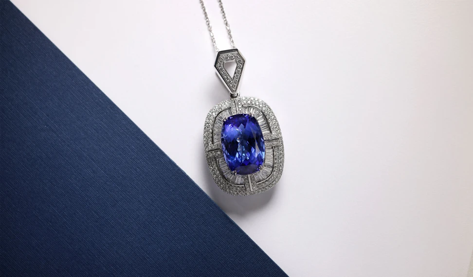 <p>A striking tanzanite pendant by the Royal Touch Group, surrounded by fancy-cut white diamonds with a kite-shaped diamond-set bail</p>