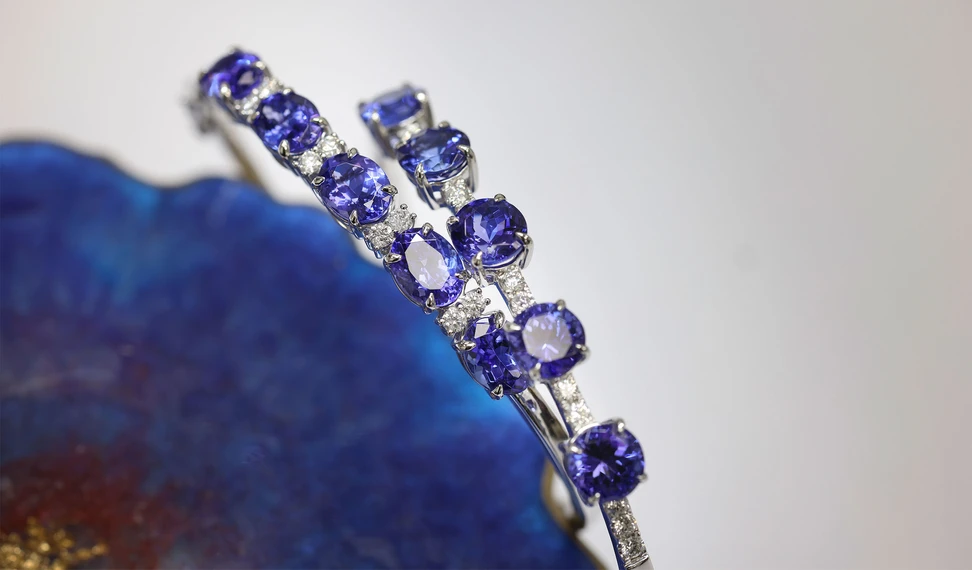 <p>A pair of bracelets by the Royal Touch Group, set with round and oval-shaped tanzanites and diamonds</p>