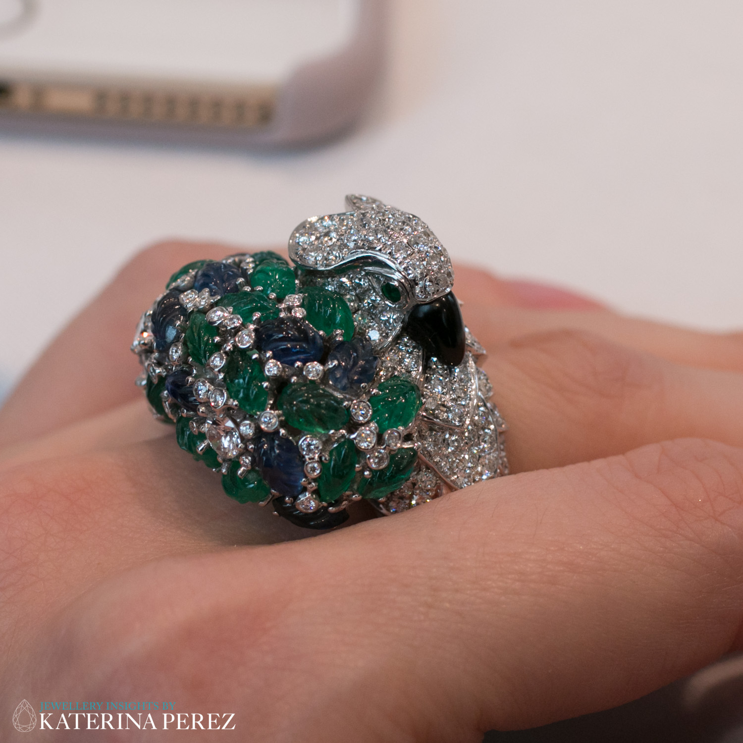 An Onyx, Emerald, Sapphire and Diamond ‘Parrot’ Ring, by Cartier, circa 1995. Eyes set with circular-cut emeralds, diamonds approximately 3.50 carats