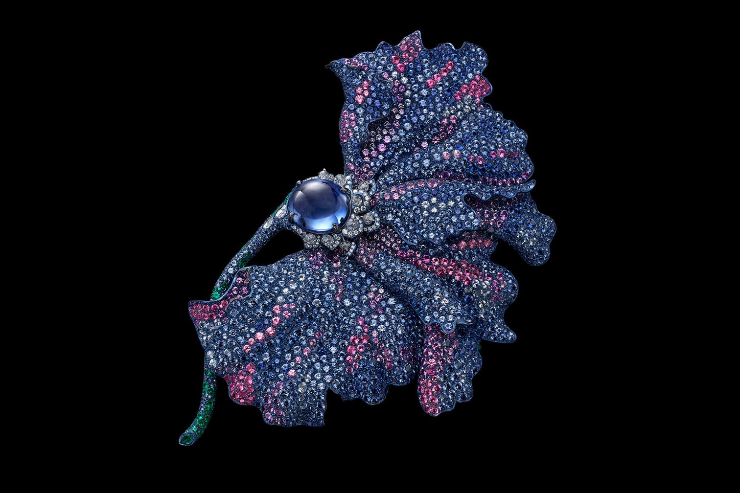 Carnet brooch with an unheated oval blue sapphire cabochon, pink, purple and blue sapphires, emeralds and diamonds set in titanum and 18K white gold