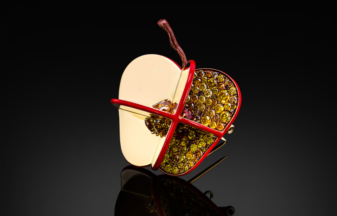 Austy Lee ‘The Apple of Singularity’ brooch from The Fruit du Désir collection in 18k yellow gold with Mozambican unheated rubies, red enamel and fancy colour diamonds