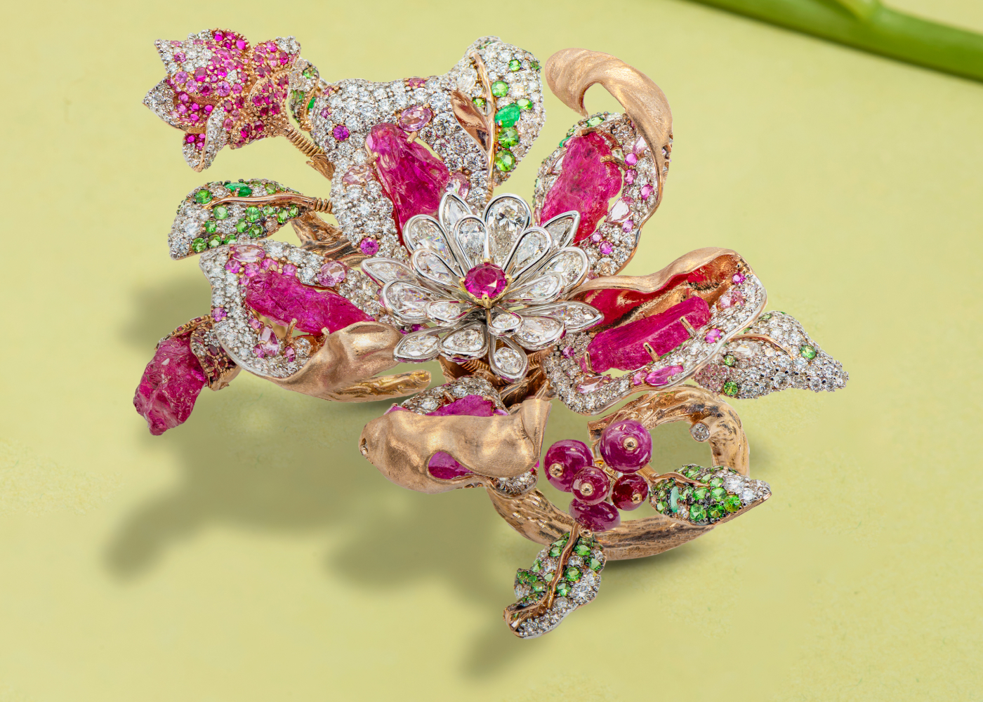 Diva Jewels Floral Bloom ring from the Marvels of Nature collection with rose-cut diamonds, further diamonds, carved rubies, ruby cabochons, and emeralds in 18k rose gold 