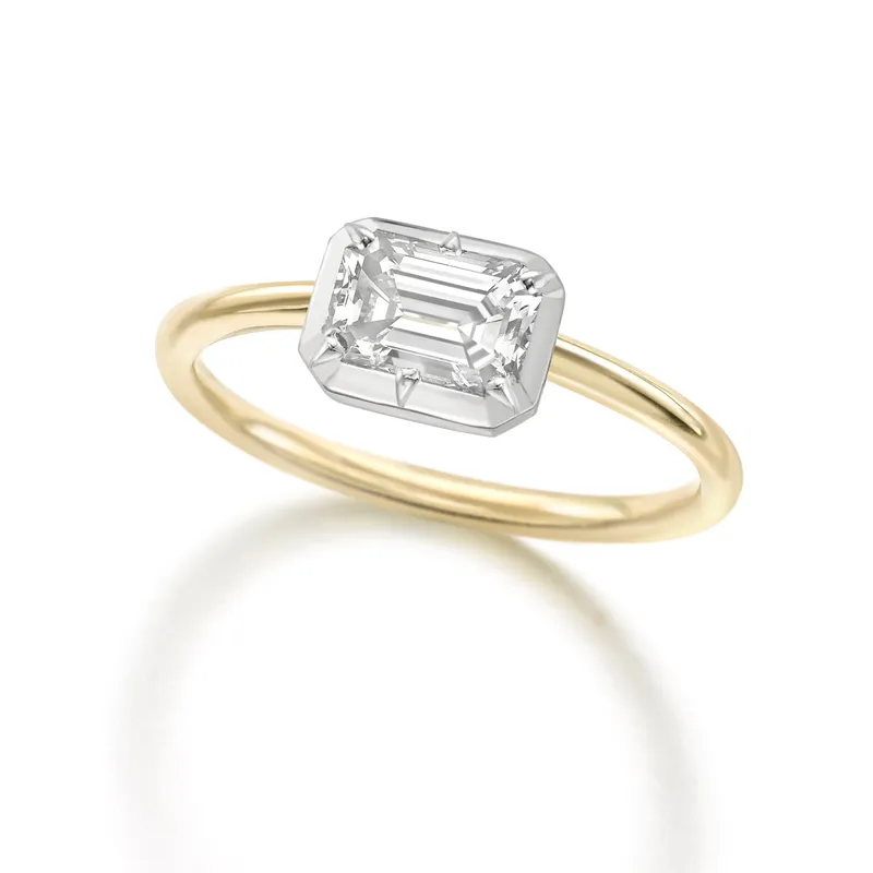 <p>Jessica McCormack Signature Button Back emerald cut diamond engagement ring in 18K white and yellow gold.</p>
