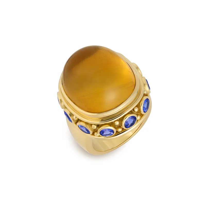 <p>Yellow beryl and tanzanite Charlemagne ring from the Elizabeth Gage New York Collection 2025, set with a cushion-shaped yellow beryl cabochon of 36.87 carats and 10 round faceted tanzanites totalling 3.42 carats, crafted in 18k yellow gold</p>