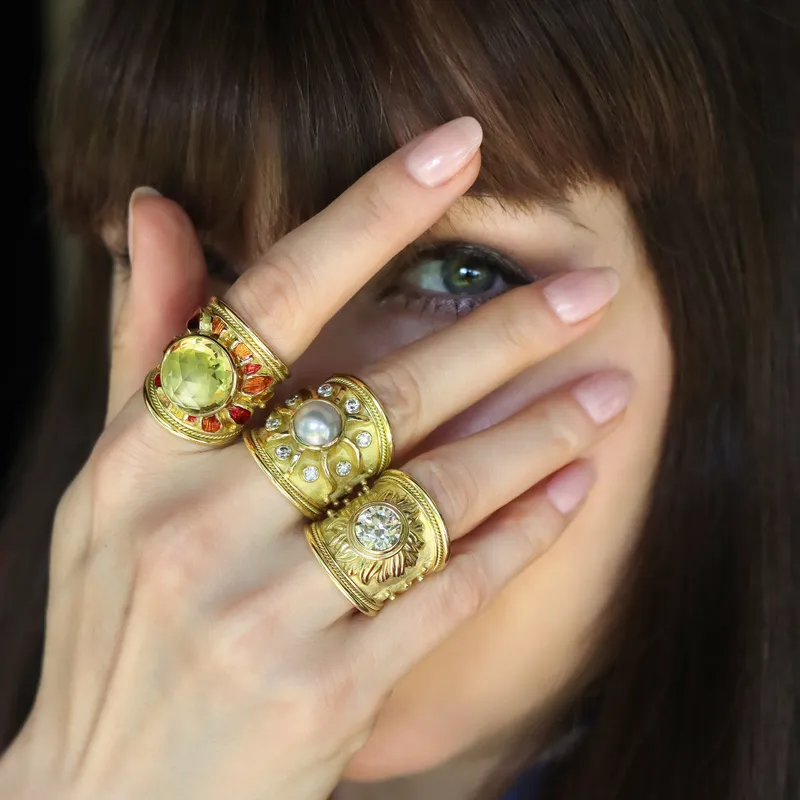 <p>Katerina Perez wears a trio of rings by Elizabeth Gage, including variations of the Sun ring with old-cut diamonds and round mabé pearls</p>
