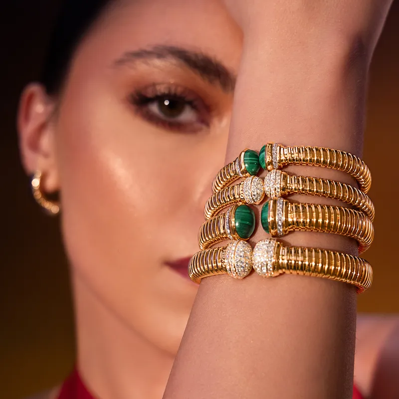 <p>A closer look at the Tourbillon collection bracelets in 18k yellow gold, set with diamonds and malachite</p>
