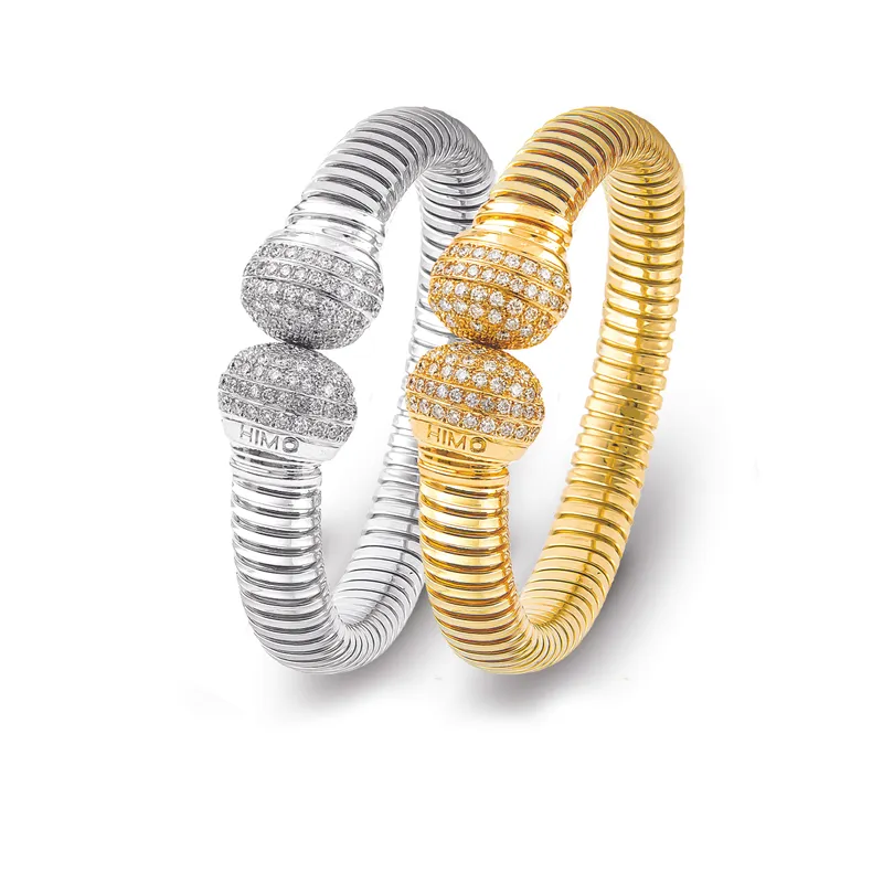 <p>A pair of Tourbillon collection bracelets with diamonds in 18k white and yellow gold</p>
