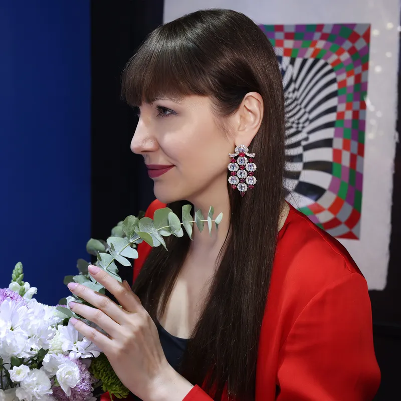 <p>Katerina wears the Marina B Shirine high jewellery earrings, set with 21.60ct oval aquamarines, 11.61ct pear-shaped rubellites and 10.95ct pavé diamonds in 18k yellow gold</p>