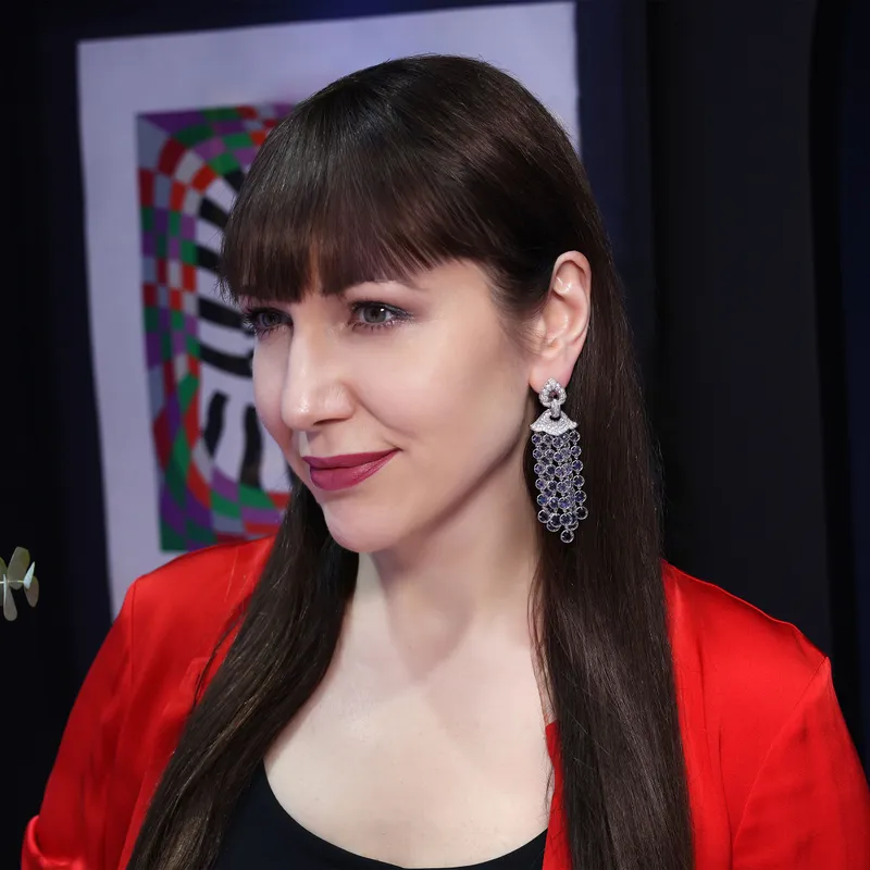 <p>Katerina wears the Marina B Pampilles high jewellery blue zircon and diamond earrings in 18k yellow gold</p>