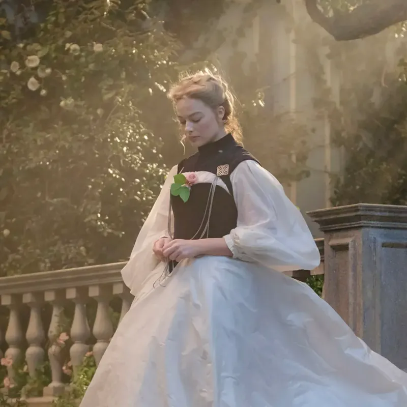 <p>Here, Robbie wears a brooch pinned to her flowing dress</p>