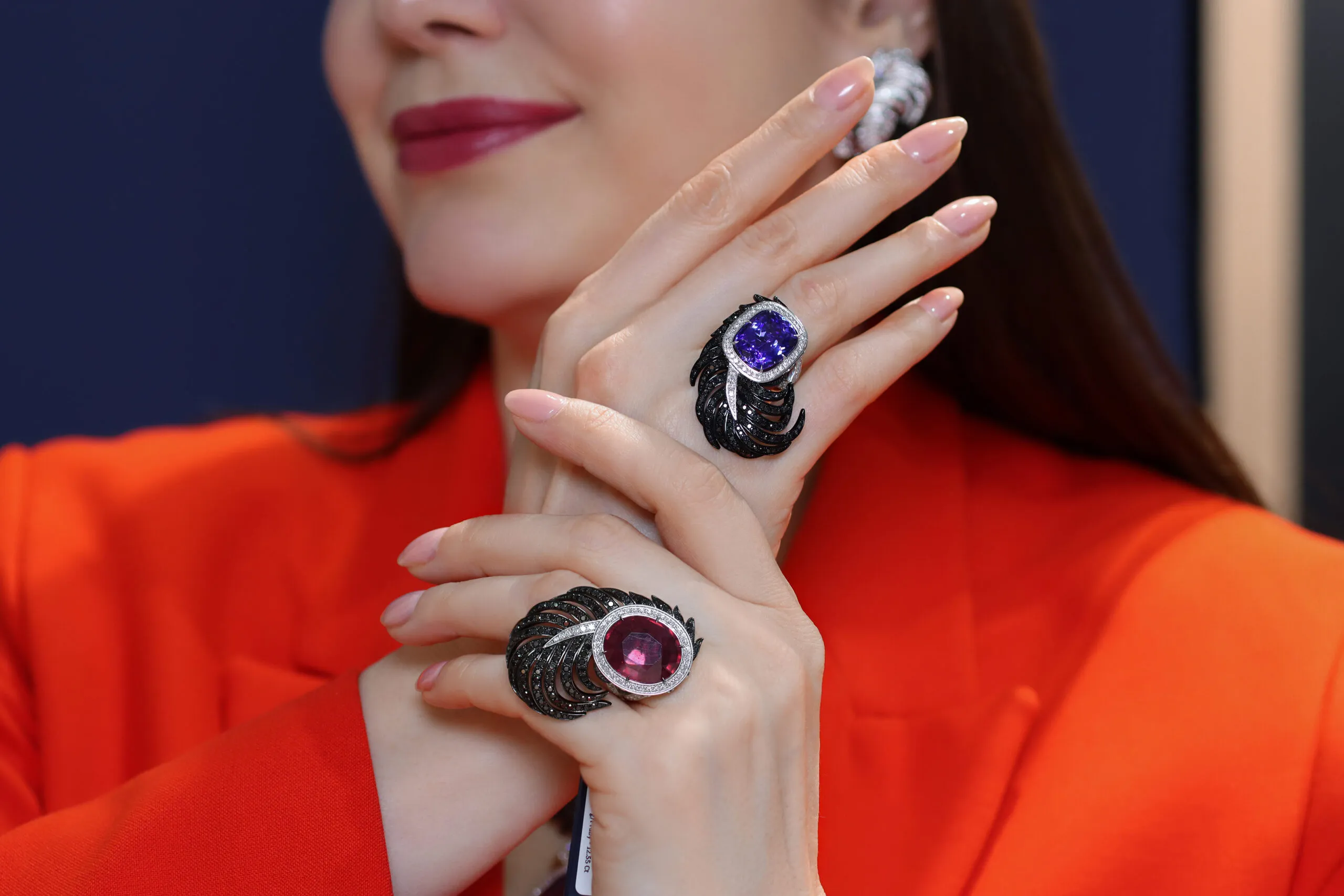 Katerina Perez wears Vamp rings by Elena Semy Jewellery, including one set with a 12.55 carat oval-shaped ruby, further rubies, 1.31 carats of black diamonds and 0.70 carats of white diamonds in 18k white and black gold 