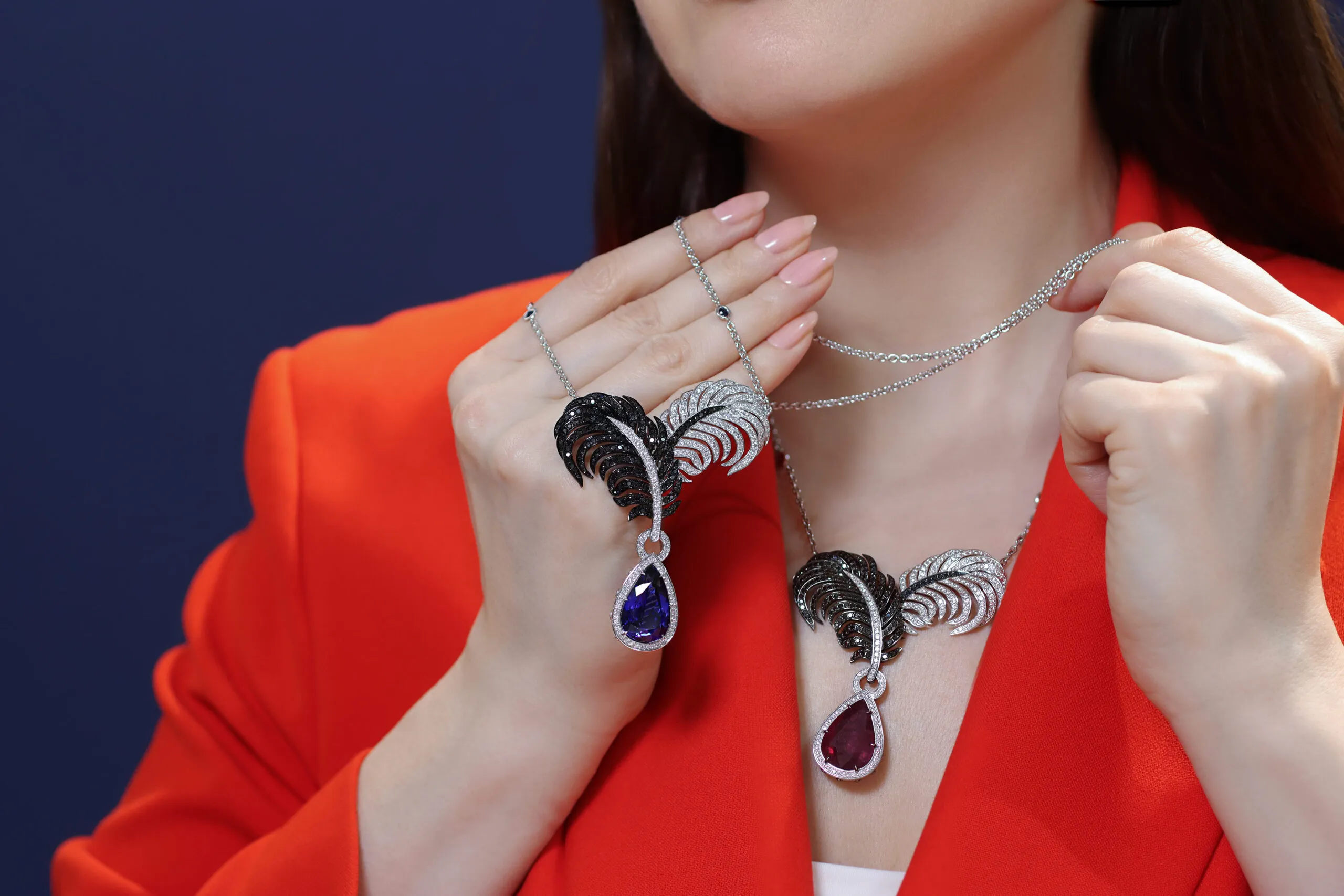 Katerina Perez wears a pair of Elena Semy Jewellery Vamp necklaces, including a piece with a 14.05 carat pear-shaped ruby, further rubies, 2.44 carats of black diamonds and 2.18 carats of white diamonds in 18k white and black gold  