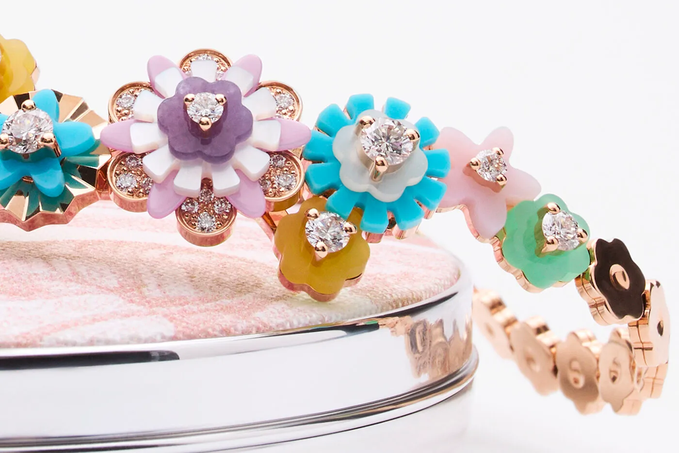 Close up of Dior Diorigami necklace with diamonds, chrysoprase, turquoise, yellow agate, lepidolite, white mother-of-pearl, pink opal, and lacquer, set in pink gold