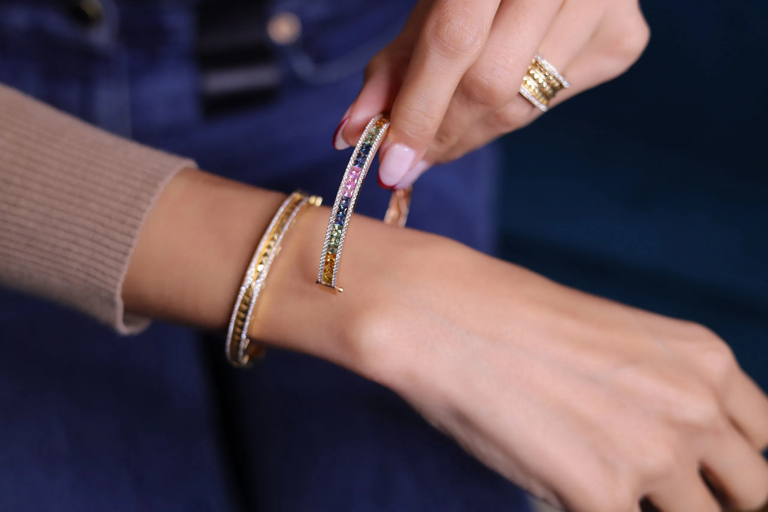The diamond, coloured gemstone and yellow gold stacking bracelets that form part of Farnoush Hamidian's personal jewellery collection 