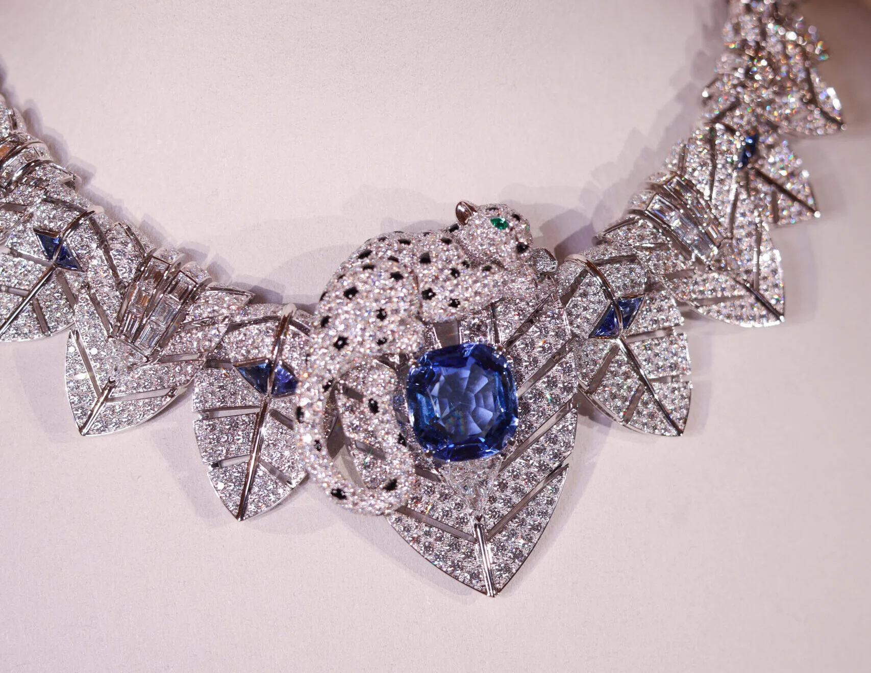 A closer look at the resting big cat that forms part of the Cartier Panthère Canopée necklace with a 26.53-carat Ceylon sapphire, trilliant-cut sapphires, round brilliant and baguette-cut diamonds, from the Nature Sauvage High Jewellery Collection Chapter III