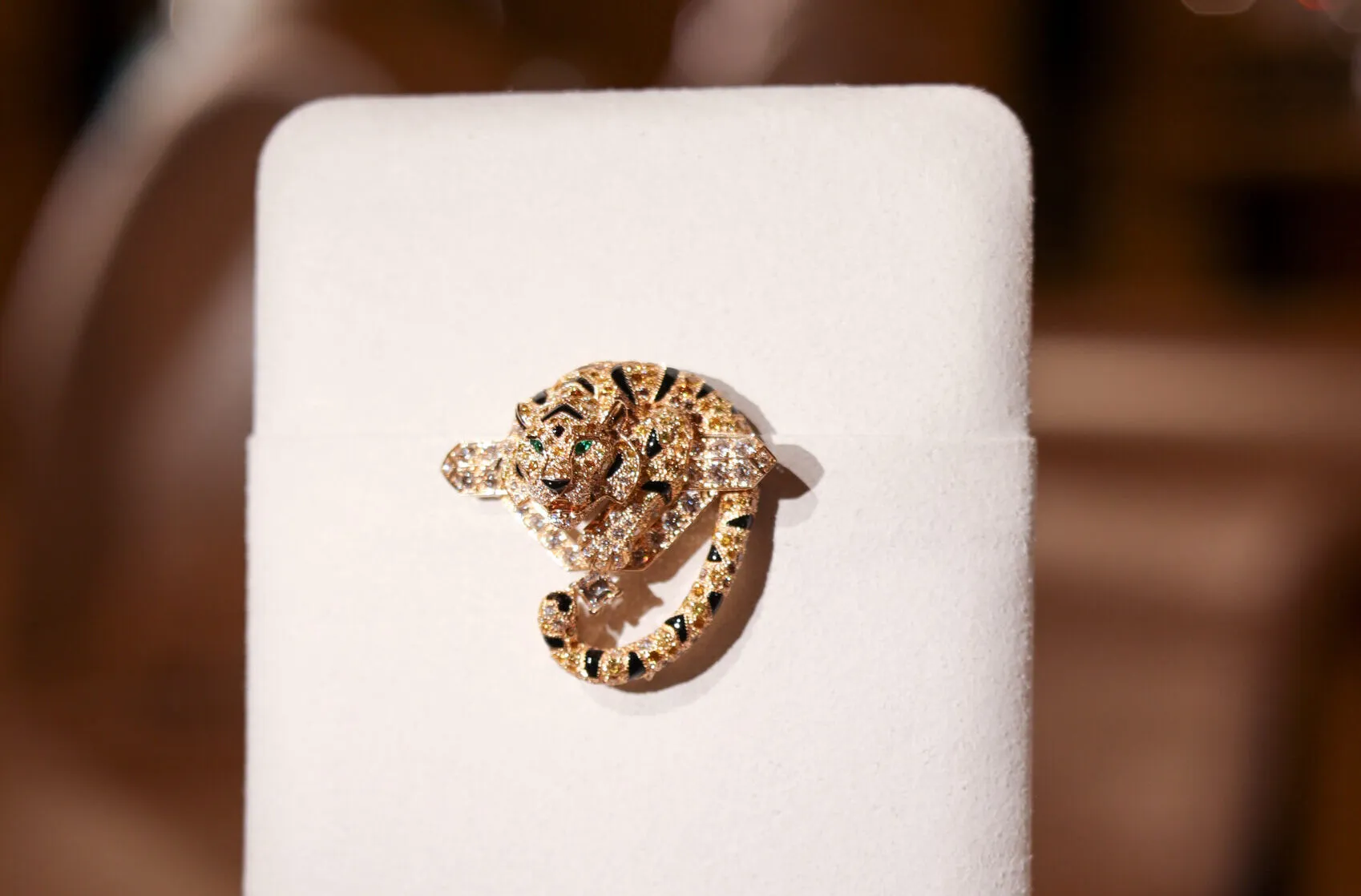 Cartier Tiger Fine Jewellery tie-pin/brooch with yellow, orange, brown and white diamonds, onyx inlay and emeralds, presented with the Nature Sauvage High Jewellery Collection Chapter III