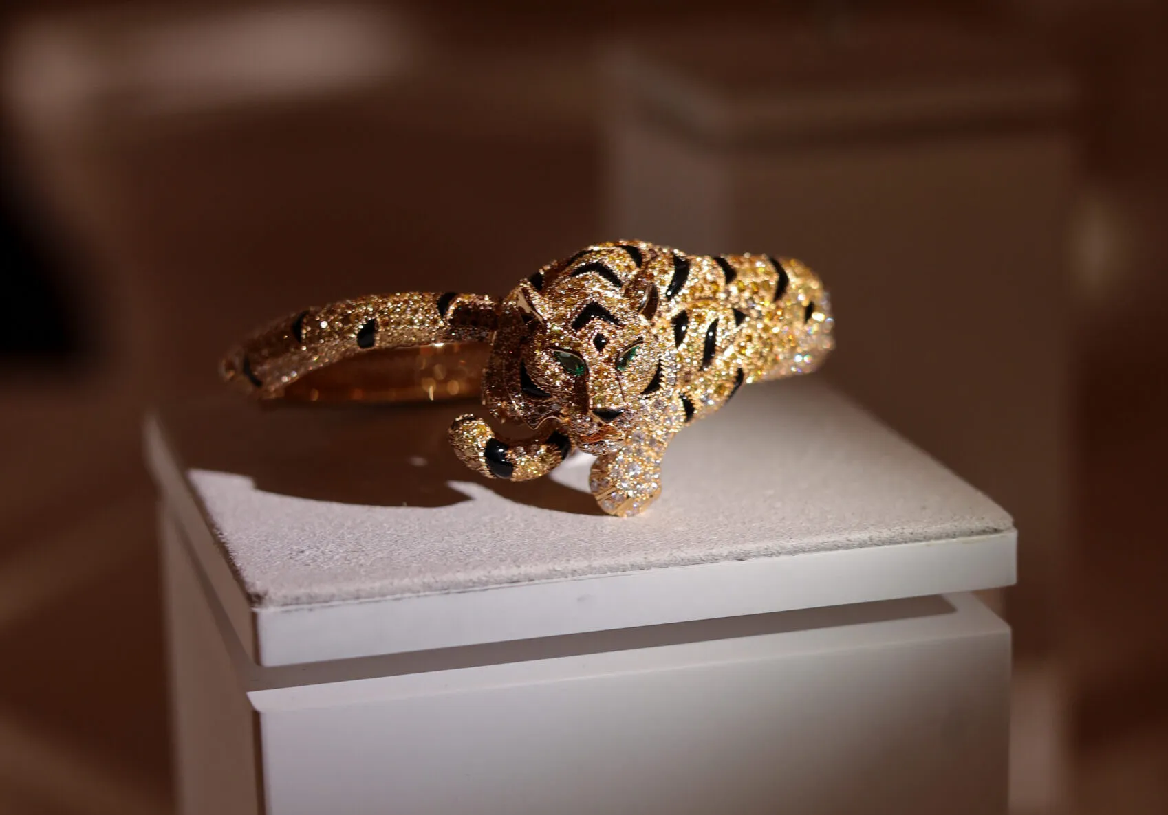 Cartier Tiger Fine Jewellery bracelet with yellow, orange, brown and white diamonds, onyx inlay and emeralds, presented with the Nature Sauvage High Jewellery Collection Chapter III