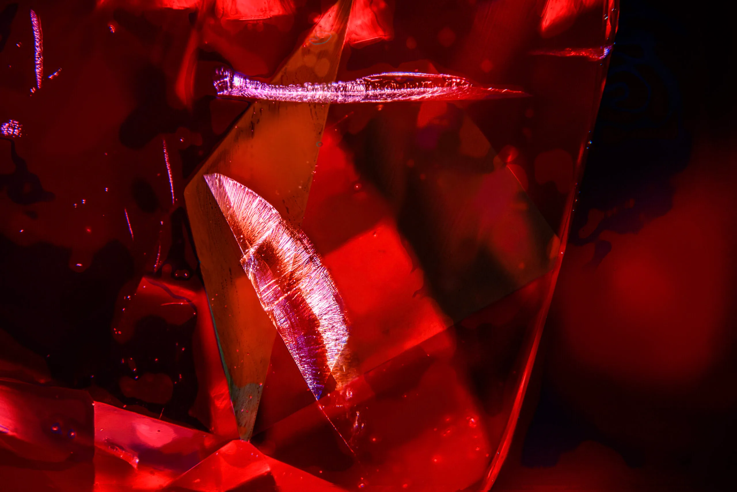 The wing shaped microscopic feature inside the 22 carat cushion-shaped Tanzanian red spinel that inspired the House of Gübelin to create the Tanzanian Sunrise High Jewellery necklace 