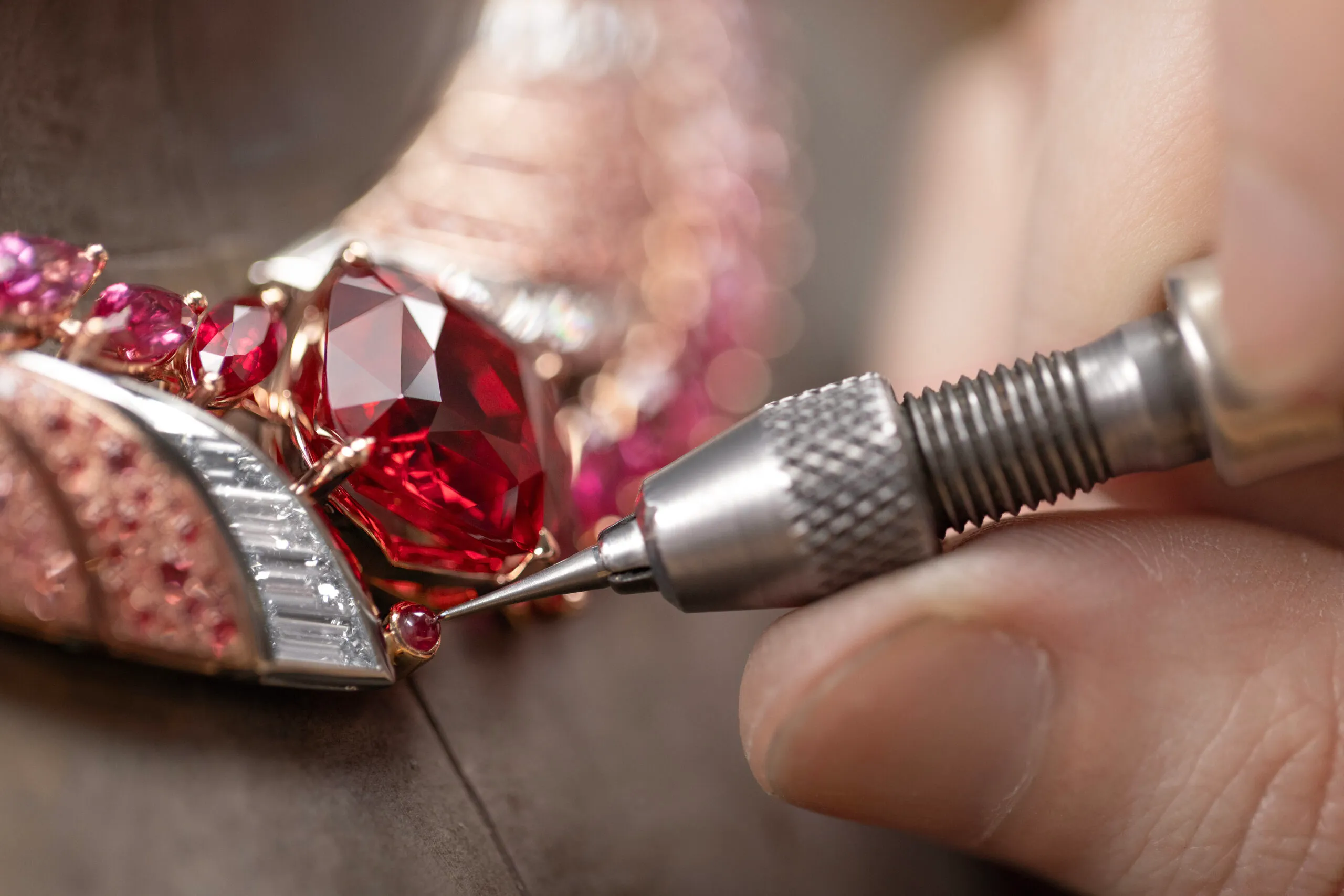 Adding the iconic Gübelin cabochon ruby to the Tanzanian Sunrise High Jewellery necklace with a 22 carat cushion-shaped red spinel from Tanzania, baguette-cut diamonds, orange and rose-coloured spinel pavé, and marquise-cut spinels, sapphires and rubies set in 18k rose gold and platinum 