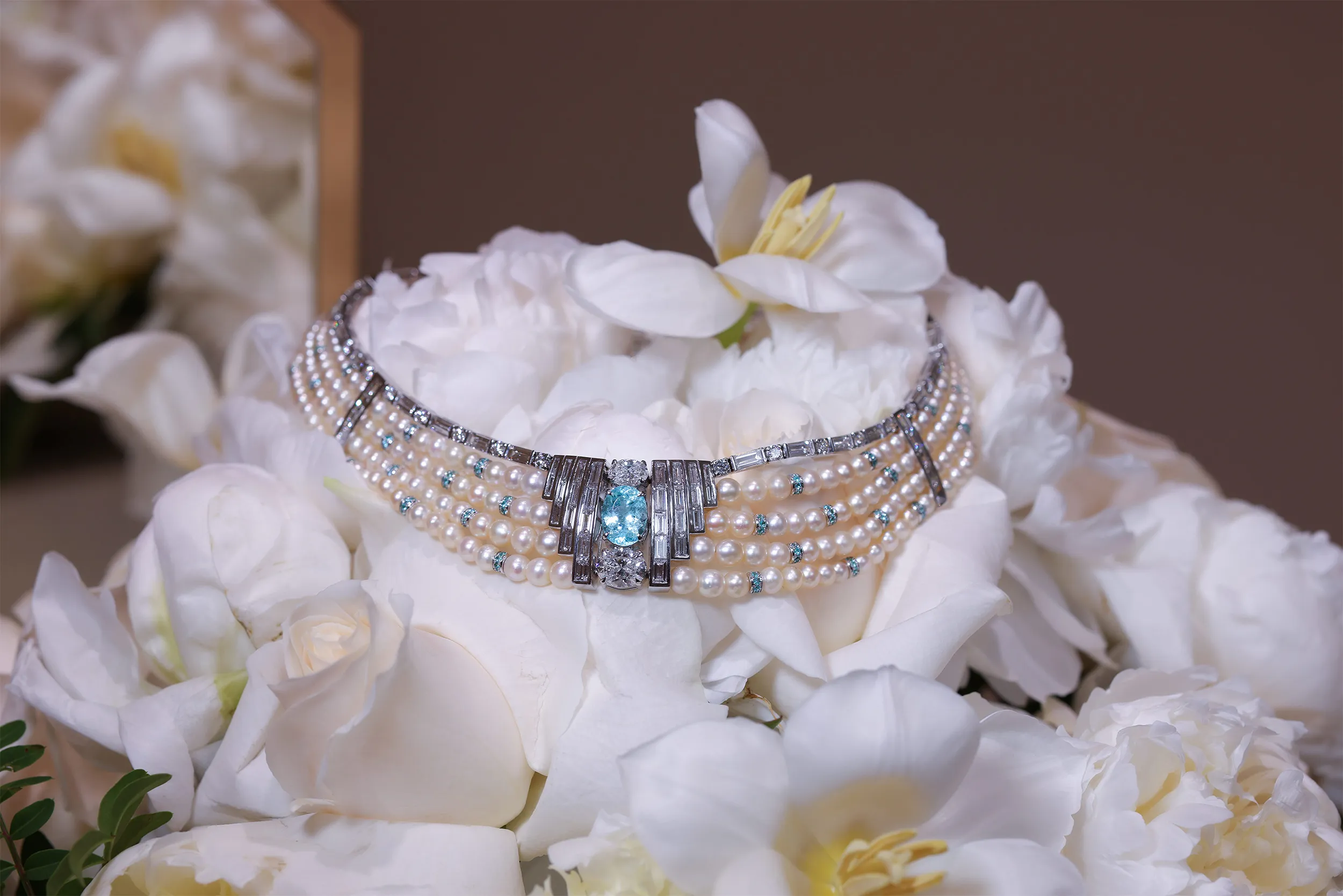 <p>Al Zain’s Arab Deco high jewellery choker wraps the wearer in an architectural embrace that frames the oval Paraiba tourmaline with sleek rows of baguette-cut diamonds</p>