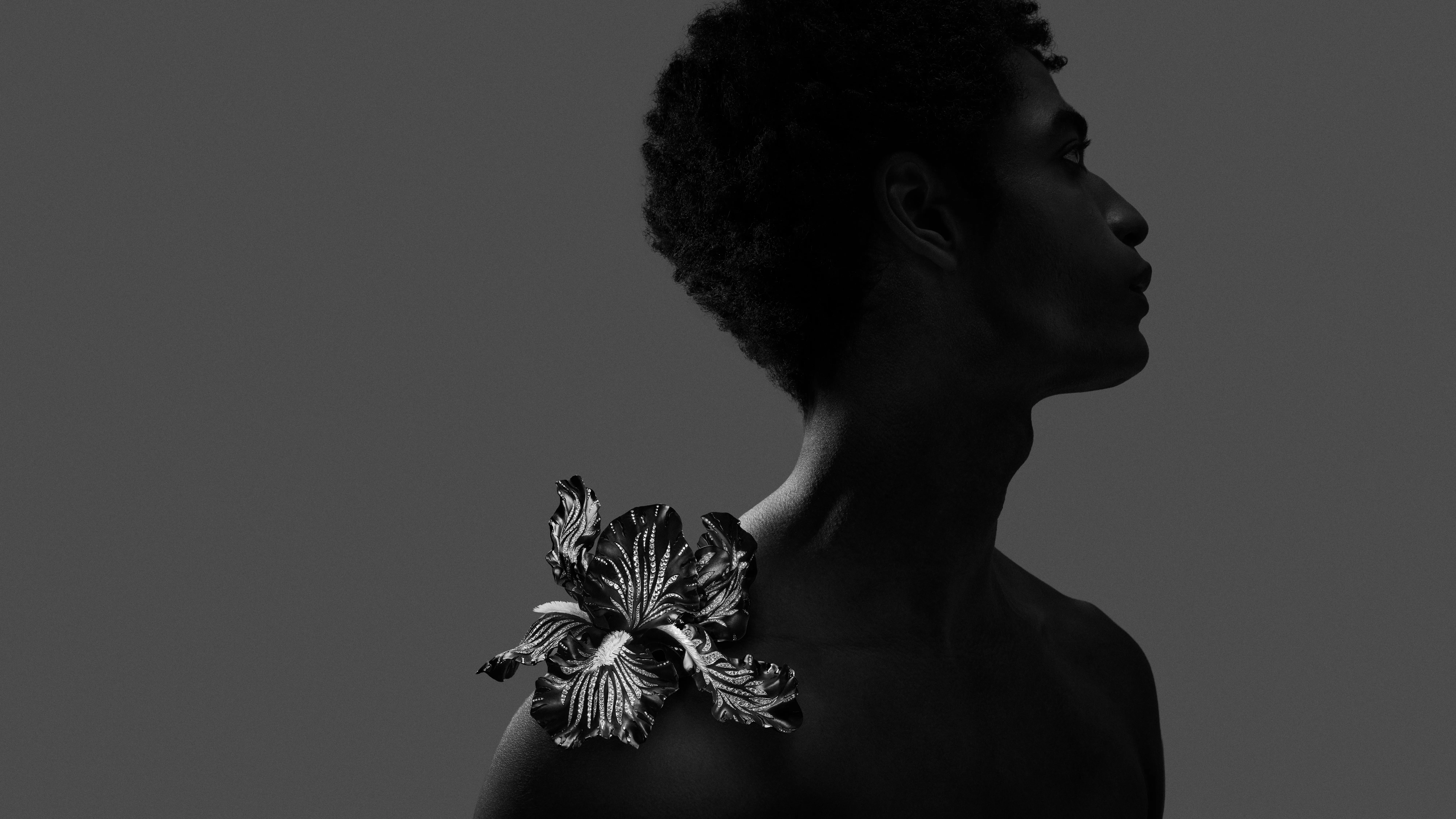 Iris shoulder brooch from Composition No.3 of the Boucheron Impermanence High Jewellery collection, crafted in titanium, white gold, black DLC coating, 3D printed resin, rock crystal, and diamonds