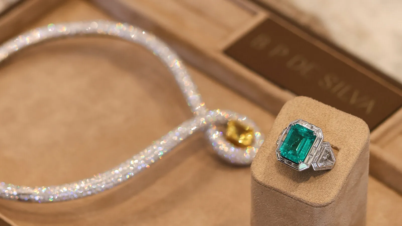 B.P. de Silva The Grand Plush sapphire necklace with a 10.50-carat emerald-cut yellow sapphire and diamonds in 18k yellow gold and platinum and the Drama Deco emerald ring with an 11.99-carat Colombian emerald and 10.65 carats of diamonds in platinum