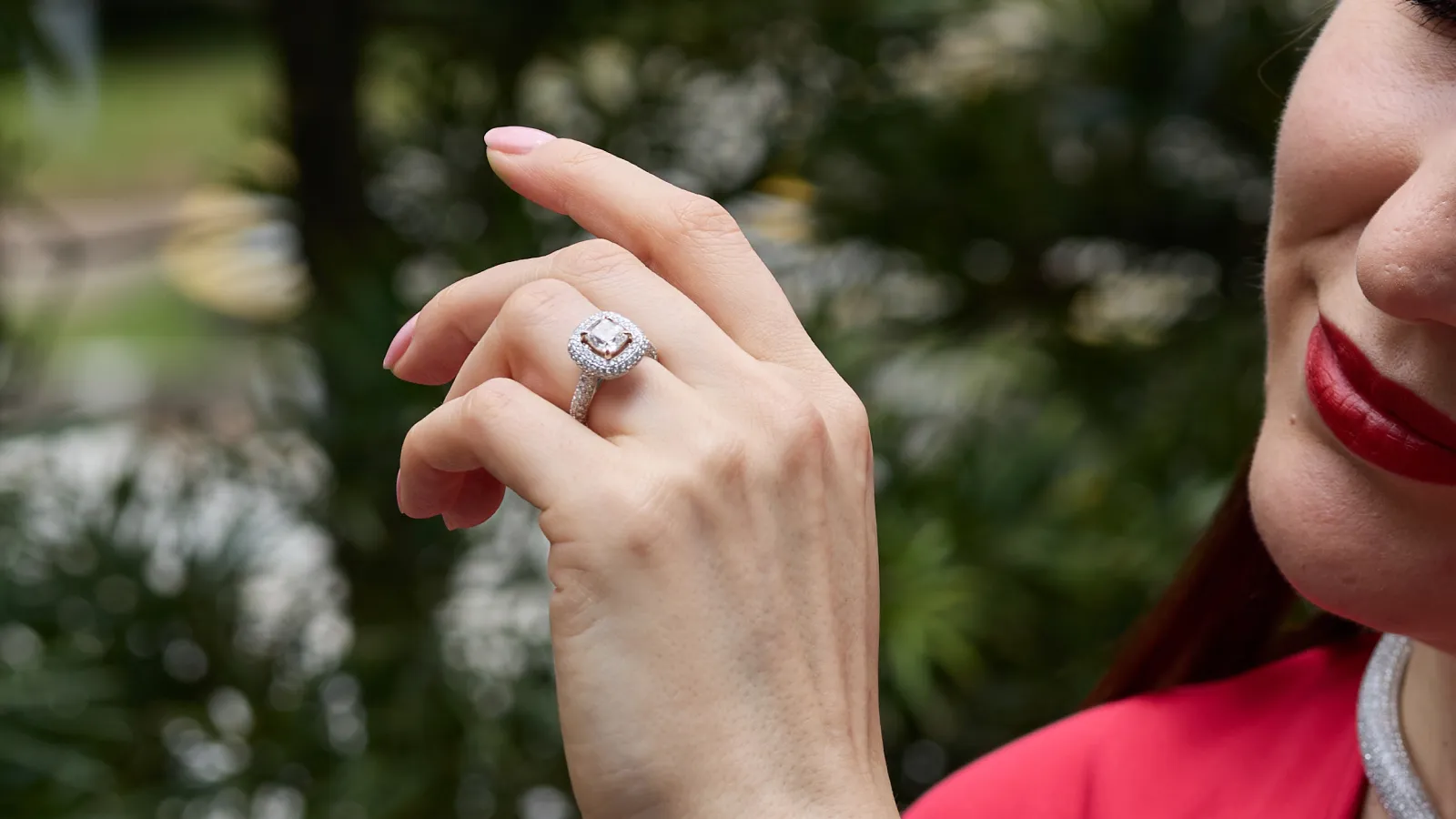 Admiring The Plush™ Signature diamond engagement ring by B.P. de Silva with a 1.49 carat cushion-cut diamond surrounded by a further 1.17 carats of diamonds, set in 18k gold