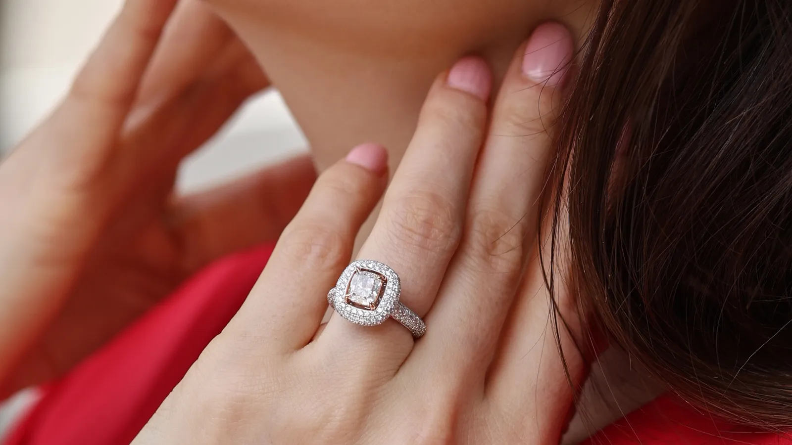 Katerina Perez wears The Plush™ Signature diamond ring by B.P. de Silva with a 1.49 carat cushion-cut diamond surrounded by a further 1.17 carats of diamonds, set in 18k gold