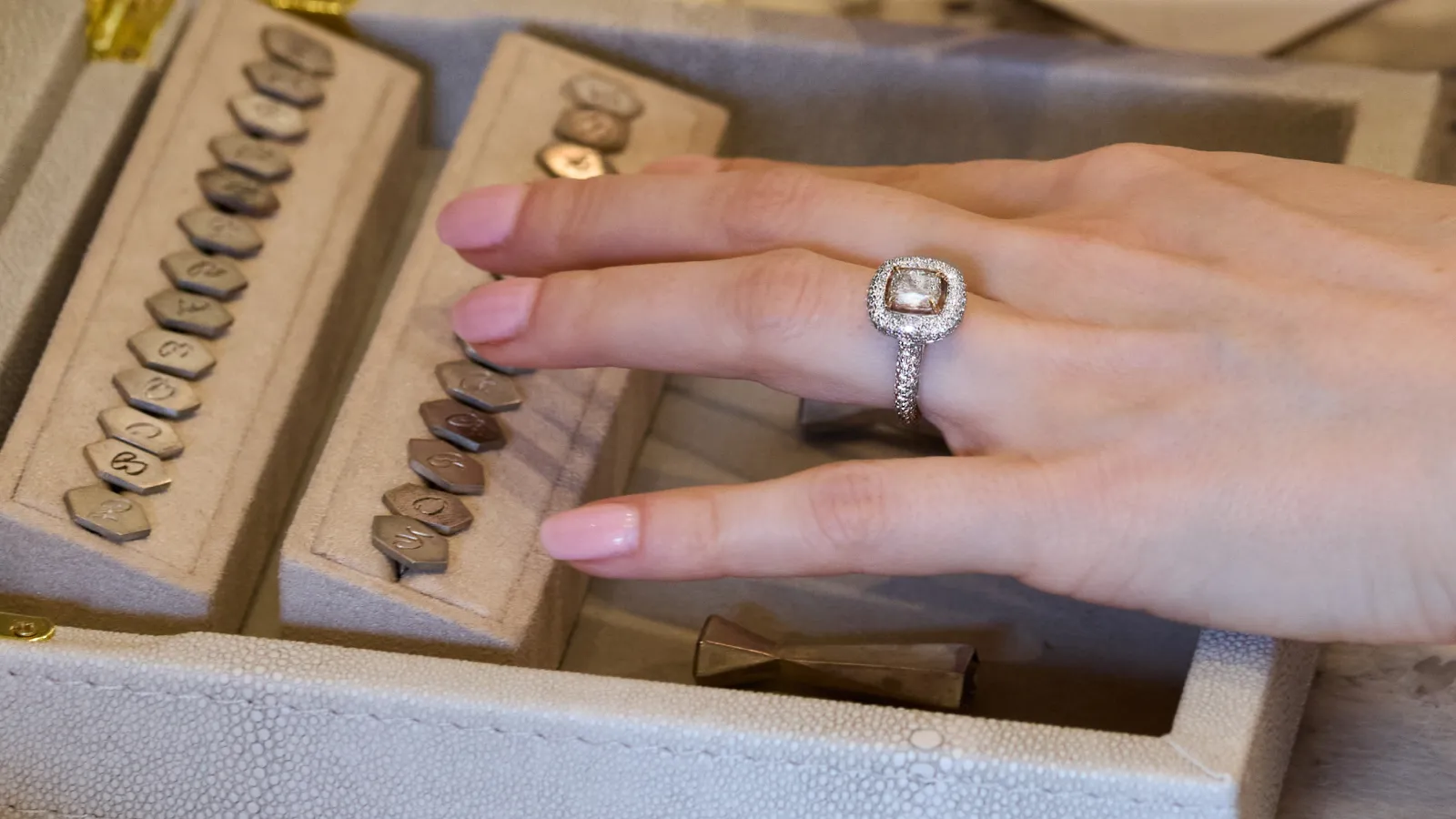 The Plush™ Signature diamond ring by B.P. de Silva with a 1.49 carat cushion-cut diamond surrounded by a further 1.17 carats of diamonds, set in 18k gold