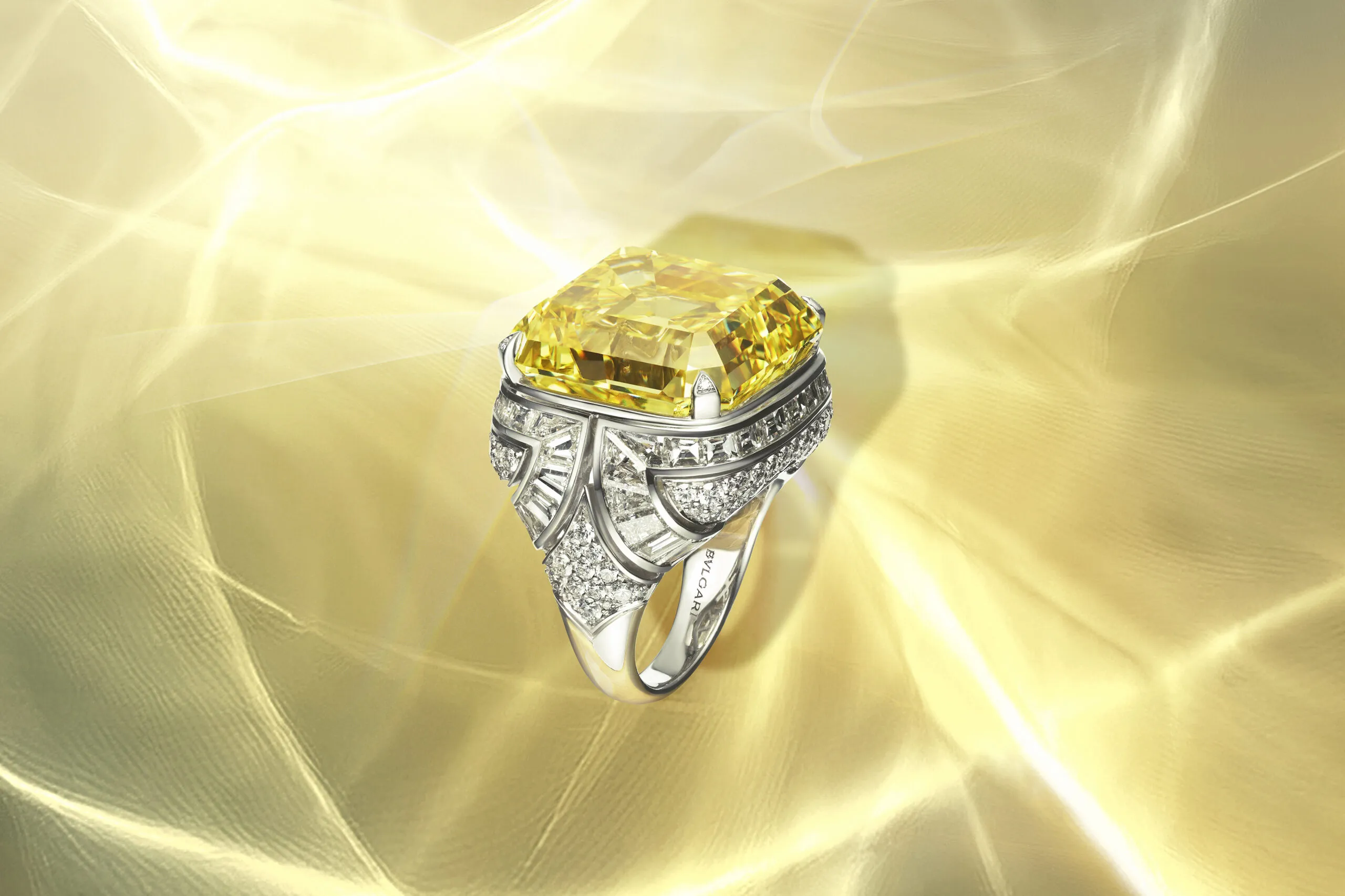 The Essence of Yellow ring features a 45-carat fancy vivid yellow diamond in an Asscher emerald shape in a shank decorated with graphic arch shapes rendered in step-cut diamonds. Bvlgari Polychroma High Jewellery 2025