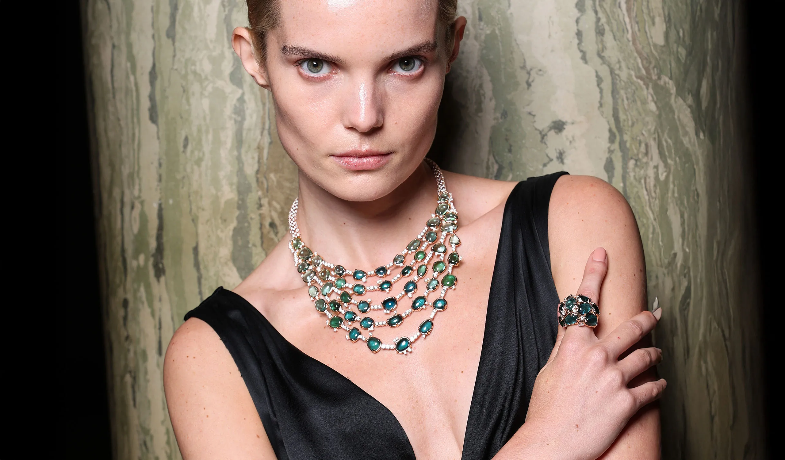 A model wears the Pomellato Lagoon Bavarole necklace with 47 irregular cut green tourmalines on a diamond pavé-set rope chain, part of the ‘Collezione 1967’ High Jewellery collection