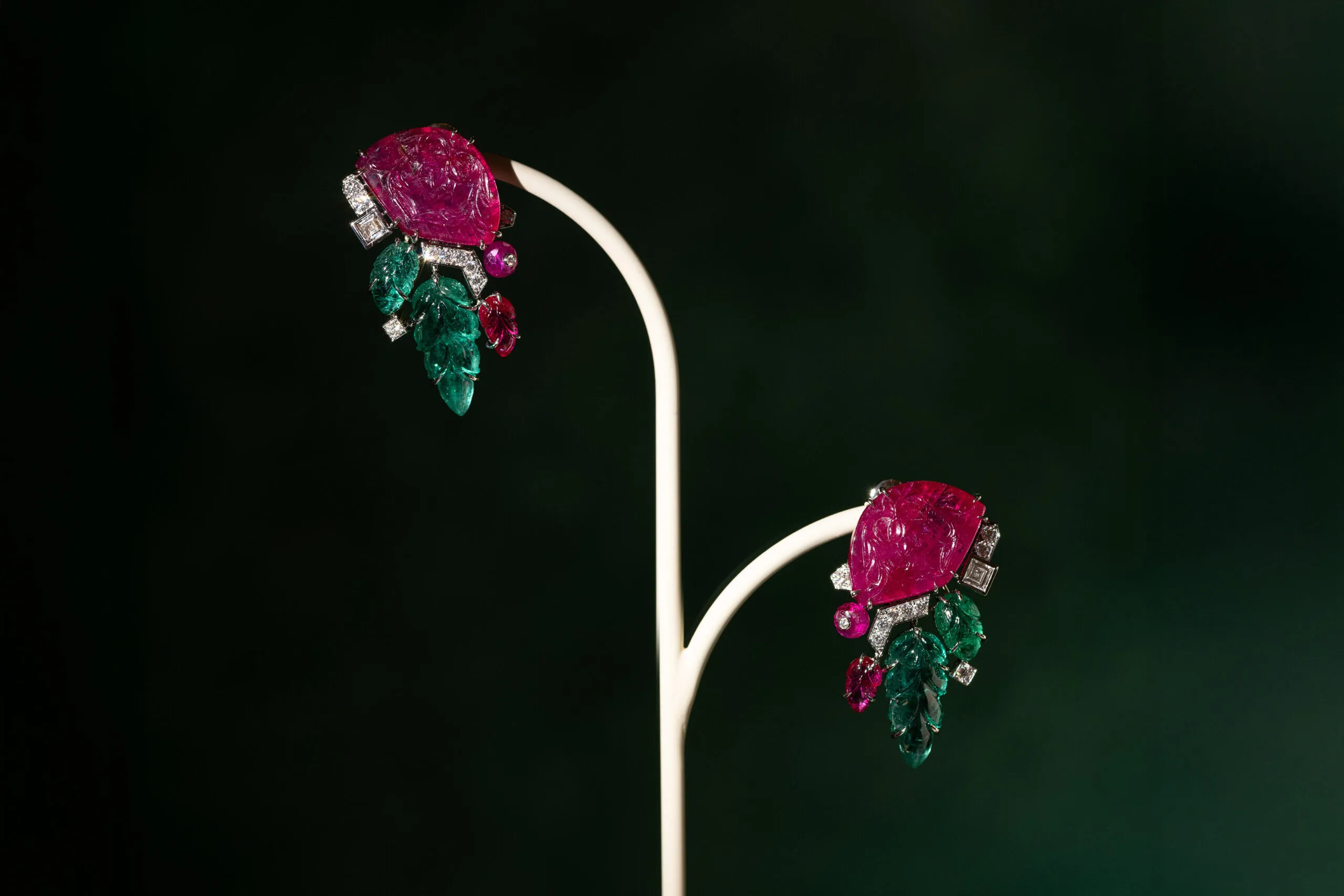 Cartier earrings with two carved rubies totalling 24.05 carats, two emerald leaves totalling 9.93 carats, plus further emeralds, ruby beads, square-shaped diamonds and brilliant-cut diamonds, set in platinum, part of the En Équilibre High Jewellery collection