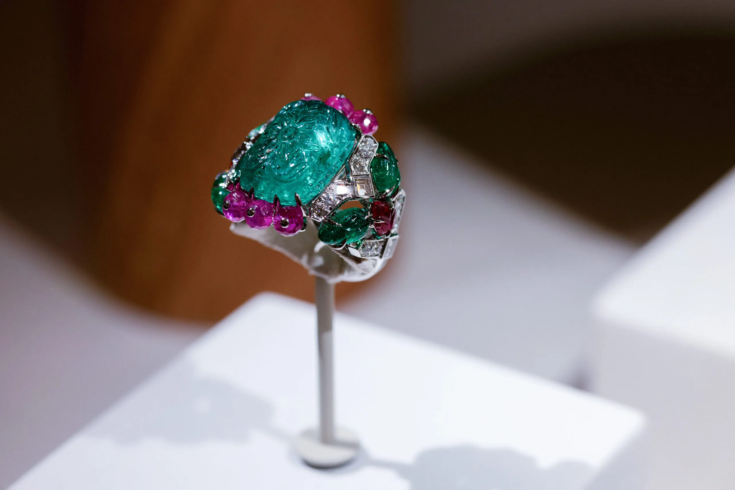 Cartier ring with a 10.99-carat carved emerald, carved emerald leaves, ruby beads and leaves, square-shaped diamonds and brilliant-cut diamonds, set in platinum, part of the En Équilibre High Jewellery collection
