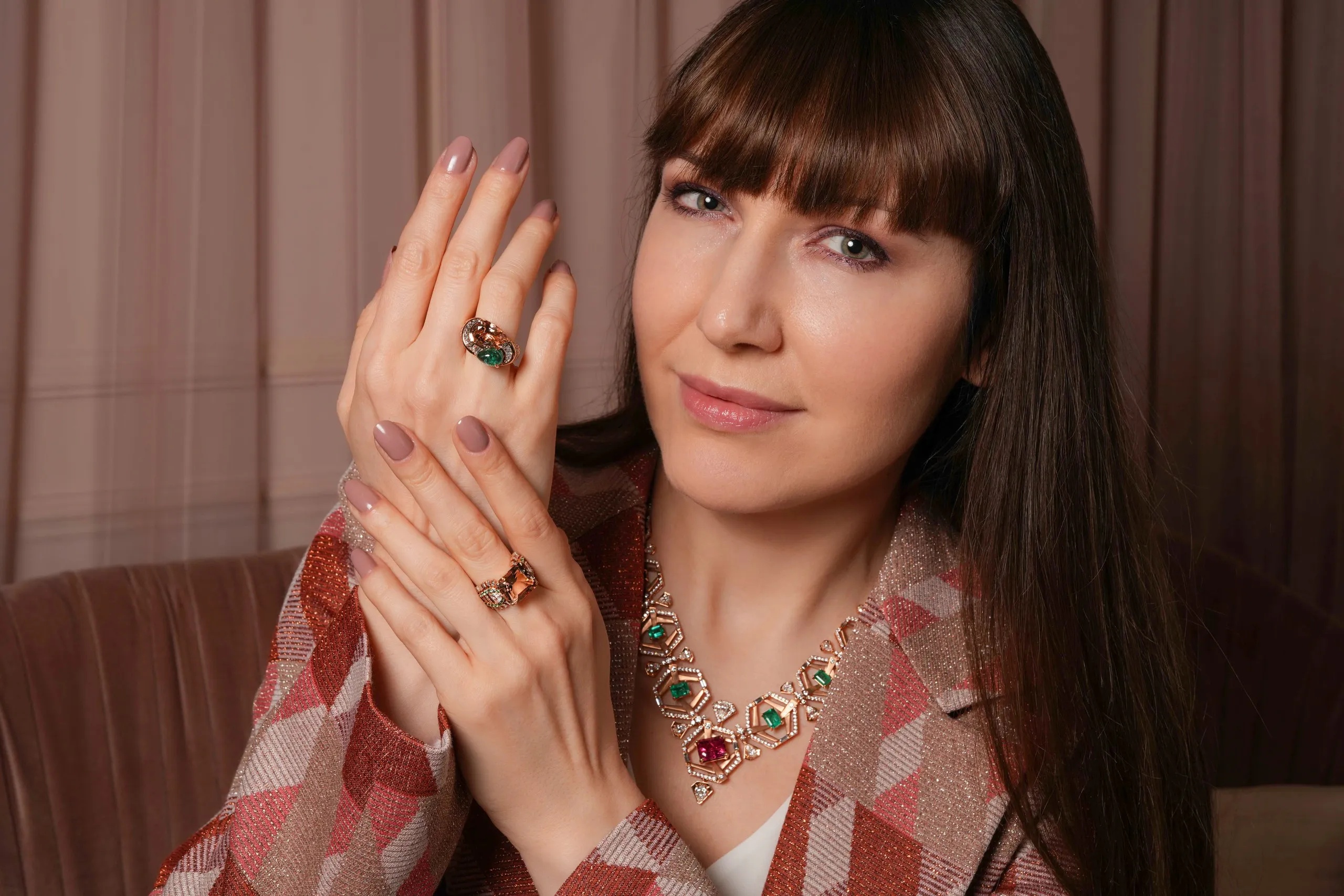 Katerina Perez wears the 'A Flush of Evergreen' necklace from Zoya's Beyond collection with unusual combinations of morganites and emeralds, finding inspiration in the flow of the mighty Indus river