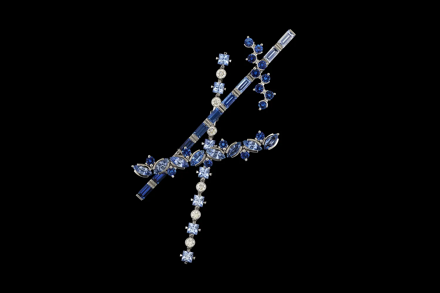A brooch-pin from the Diorexquis High Jewellery collection with fancy-cut sapphires and diamonds in a gradient of blue hues 