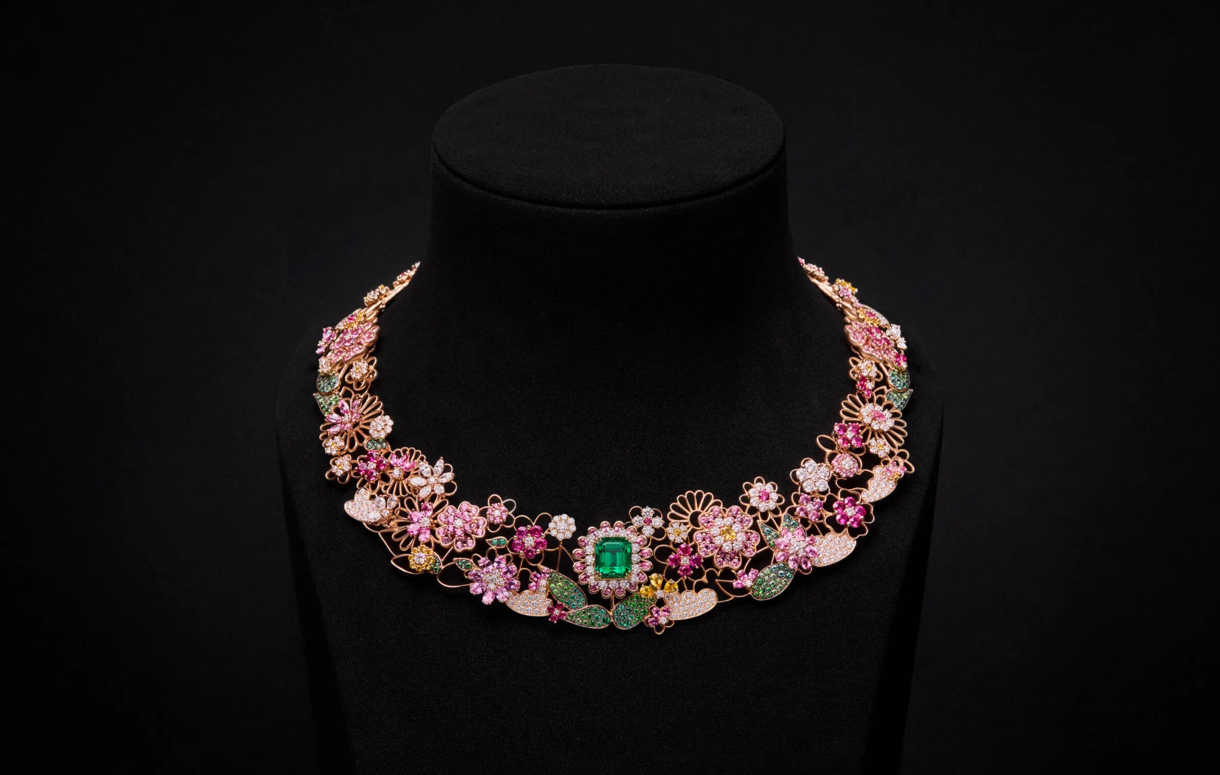 The Manege Fleuri necklace with an emerald centre stone bordered by diamonds and pear-shaped pink sapphires, plus further gem-set flowers and leaves on a rose gold framework from the Dior Milly Dentelle High Jewellery collection. Photo credit Piotr Stoklosa